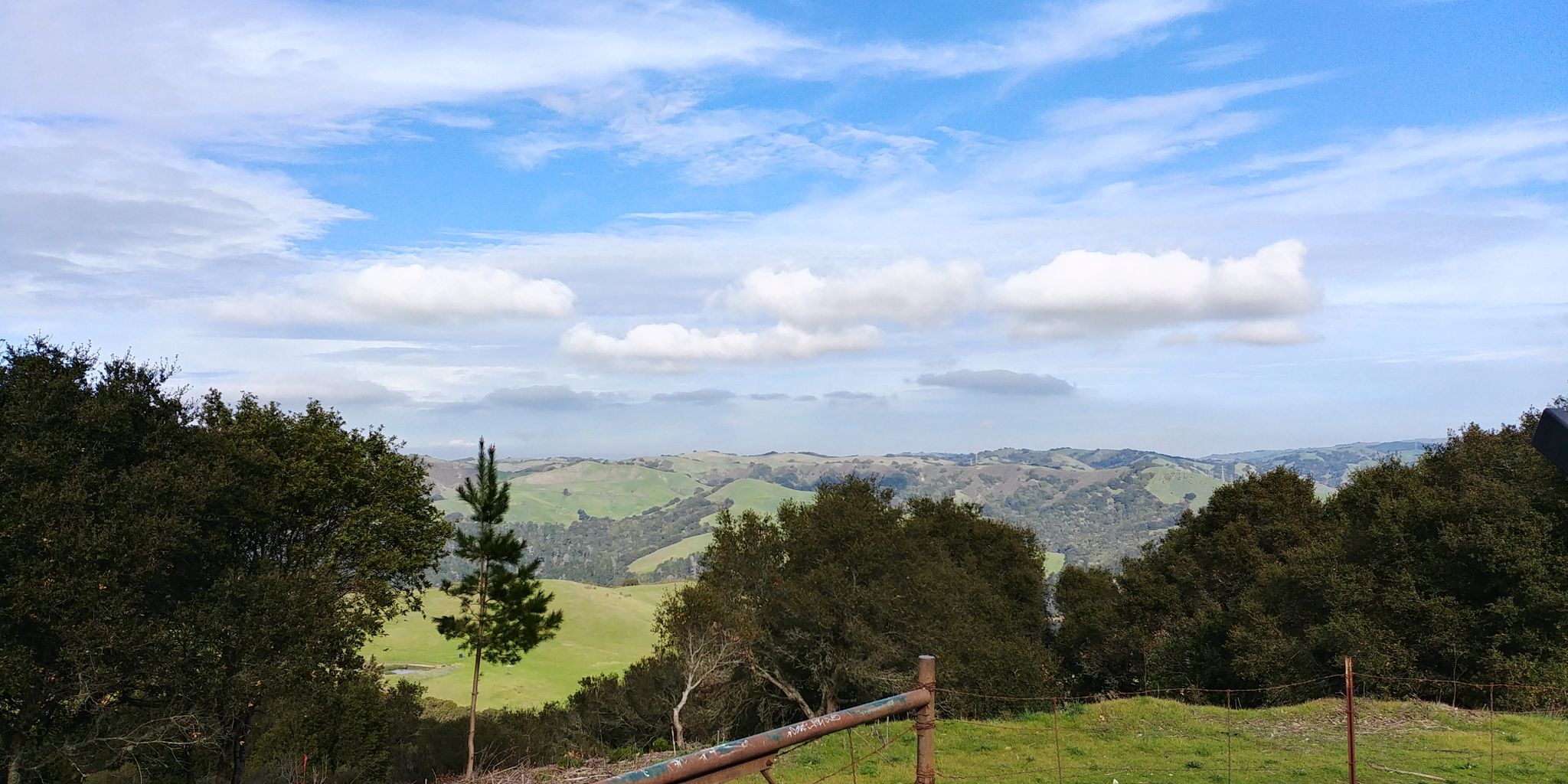 Expansive view of green rolling hills under a partly cloudy sky. - Seaview and Big Springs Trail Loop