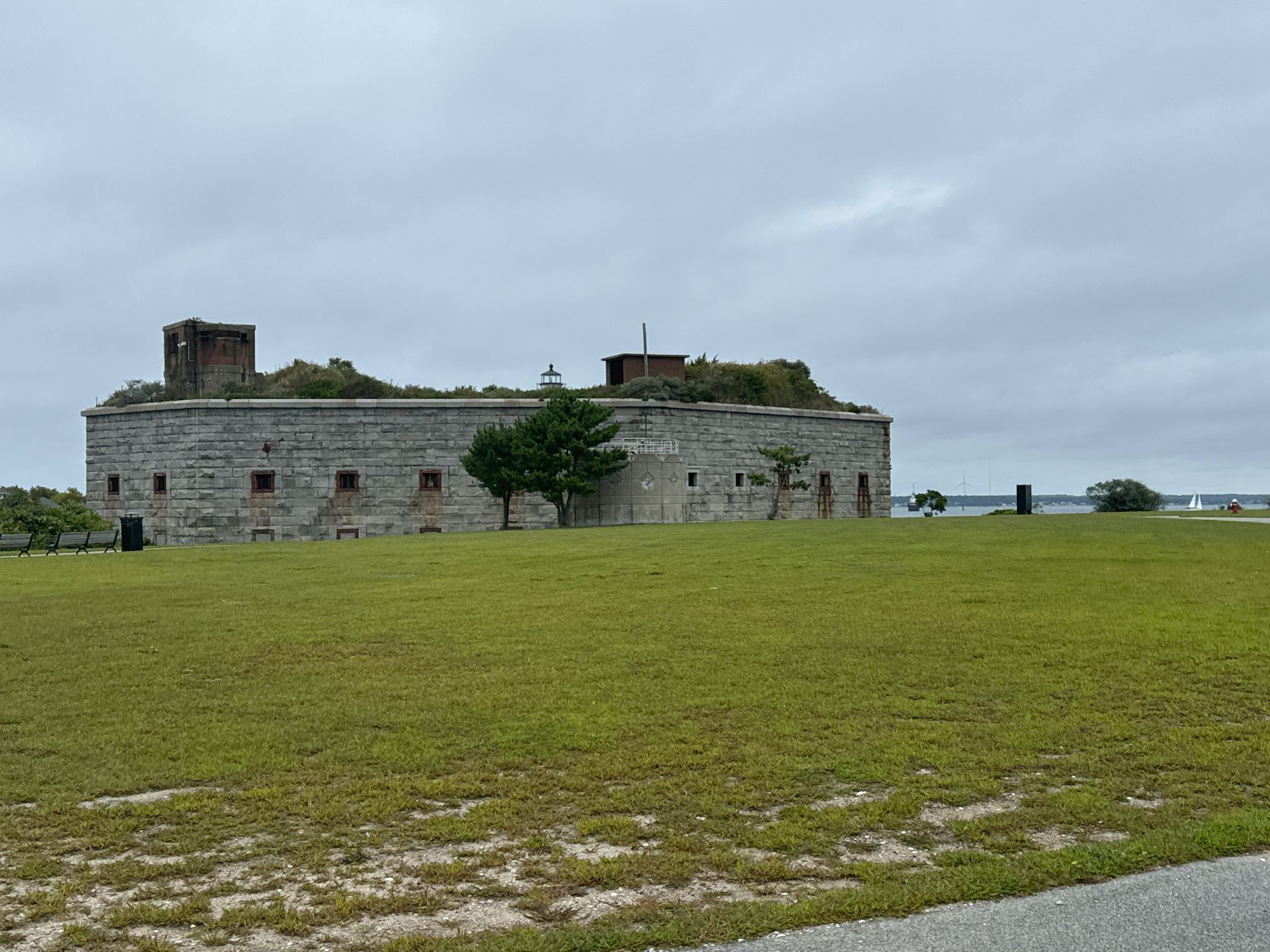 A large, old stone building with a grassy roof on a cloudy day. - Clarks Point – Fort Taber Park loop from Clark's Point Light