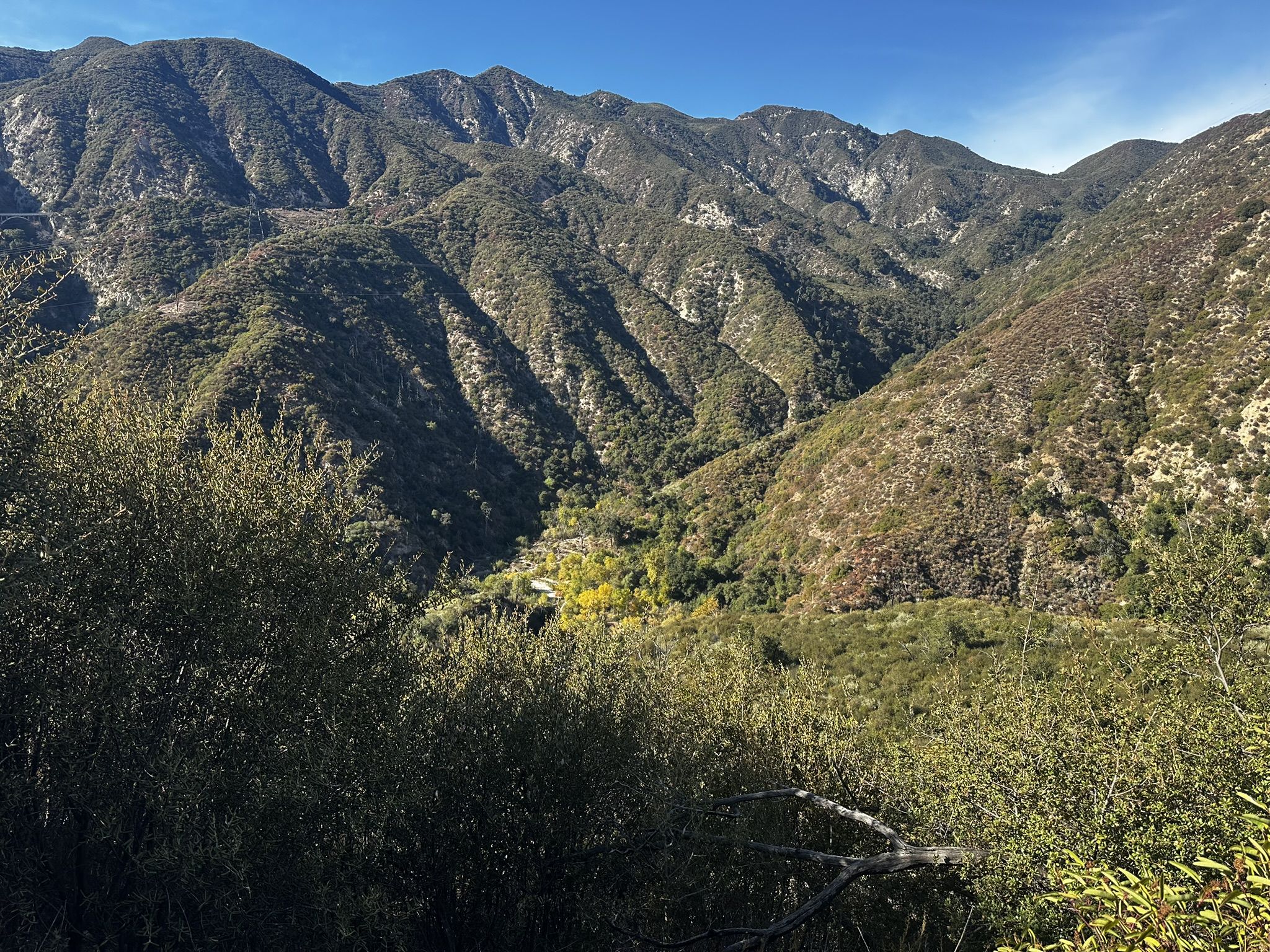 Panoramic view of sunlit, green mountain ranges and a verdant valley. - Wella's Peak – Angeles National Forest