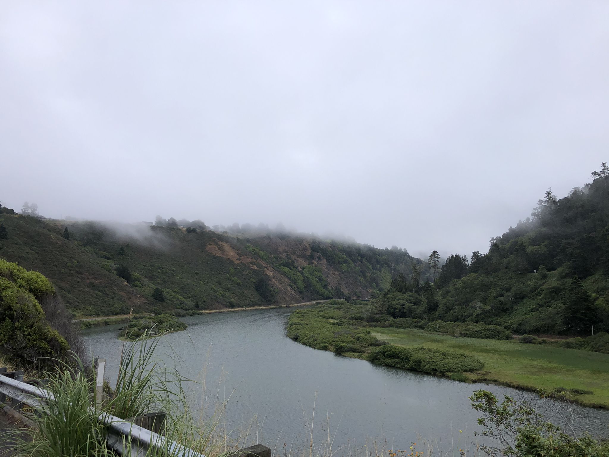 Misty river winding through green, forested hills under an overcast sky. - Albion River Bridge loop from North Fork Navarro River