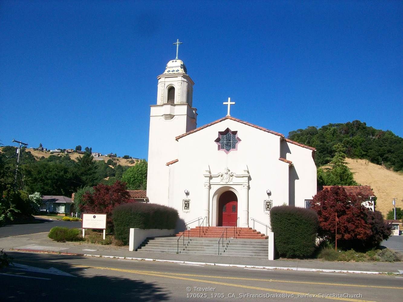 White church with a bell tower and red door under a clear blue sky. - Gestalt Haus – Fairfax loop from Sleepy Hollow