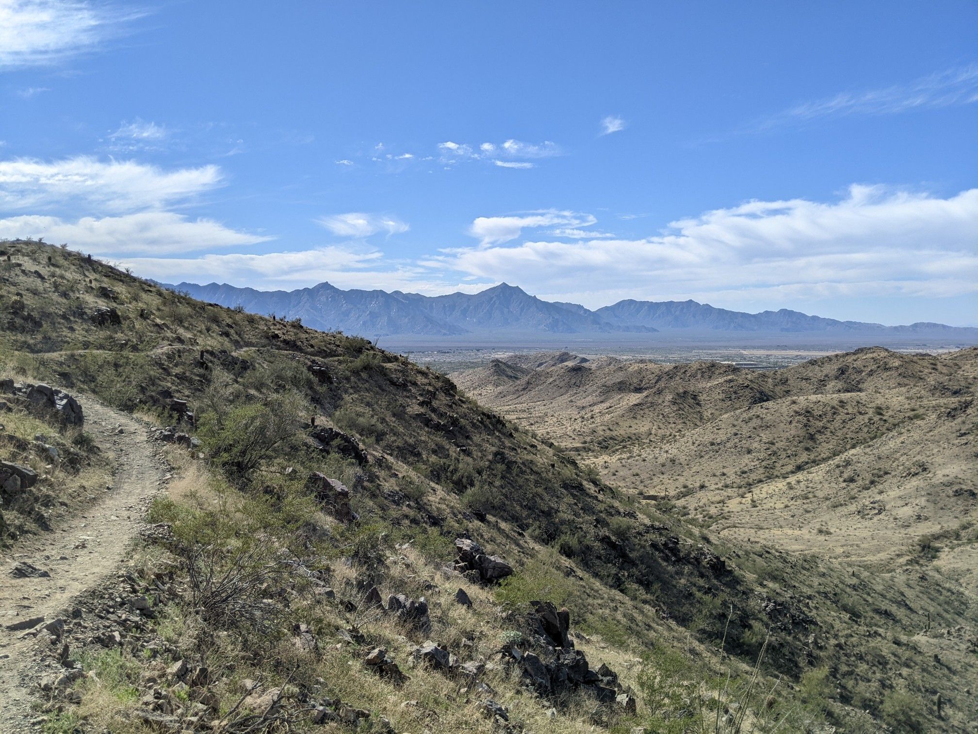 Desert mountains and valleys with a winding trail under a bright blue sky. - Goat Hill Loop via National and Pyramid Trail