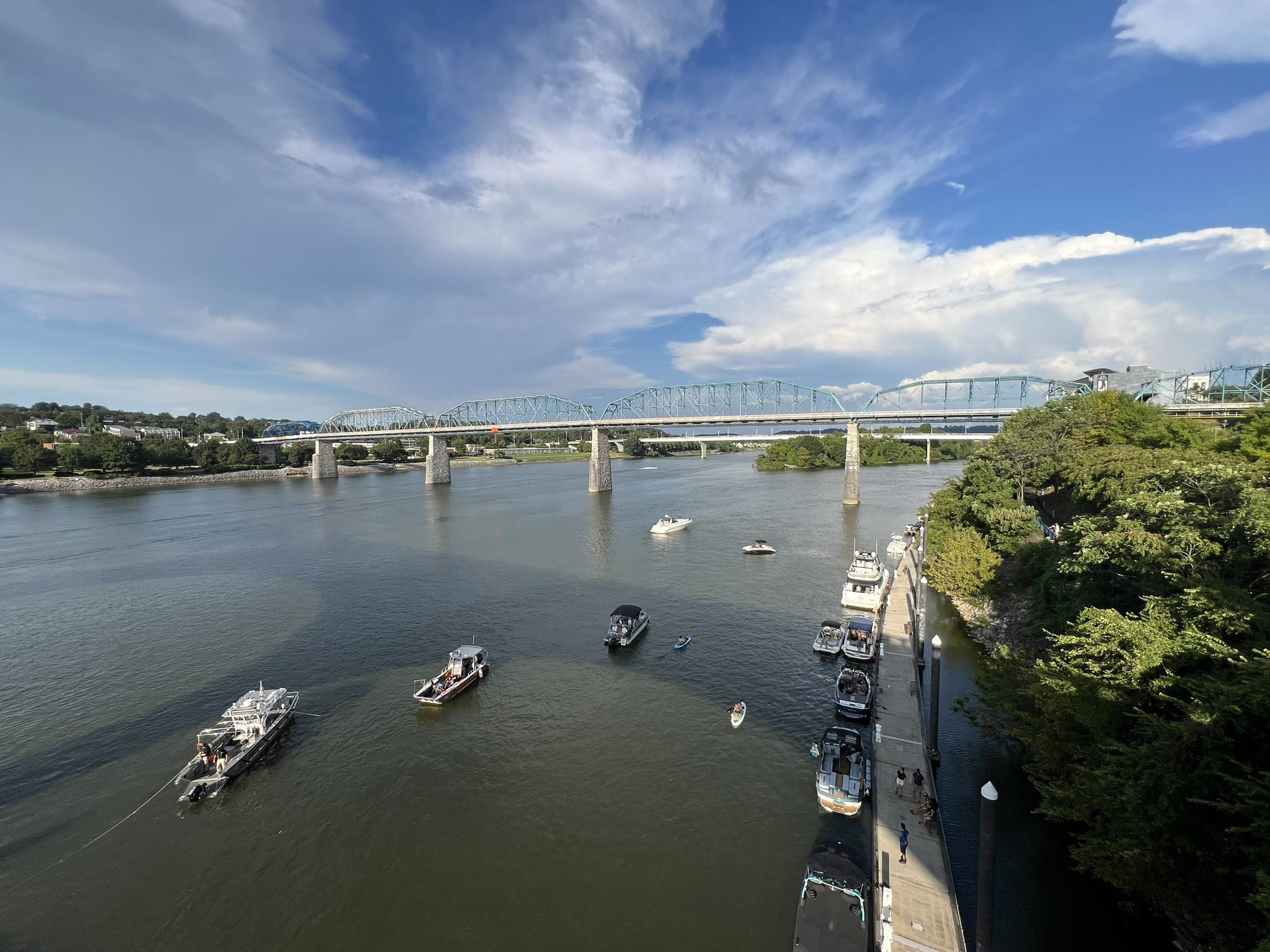 Boats on a wide river with a long bridge under a partly cloudy sky. - Prentice Cooper State Forest loop from Chattanooga