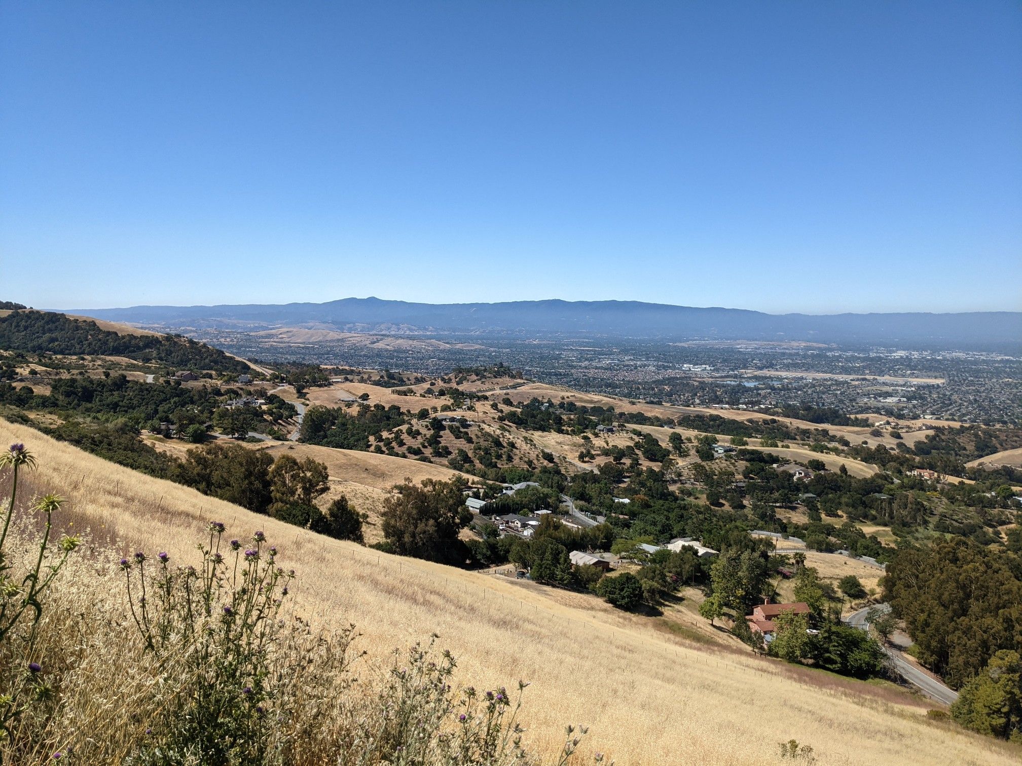 Expansive view of dry hills and a distant valley with clear sky. - Mount Hamilton & JD Grant Park loop from Berryessa