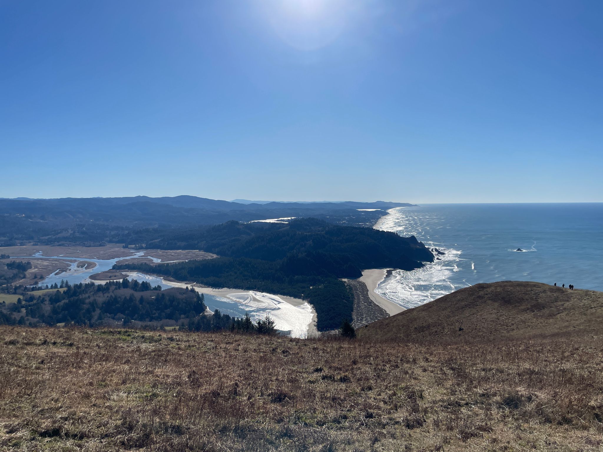 Panoramic view of a sunny coastline with ocean, river, and hills. - Cascade Head Rainforest Trail