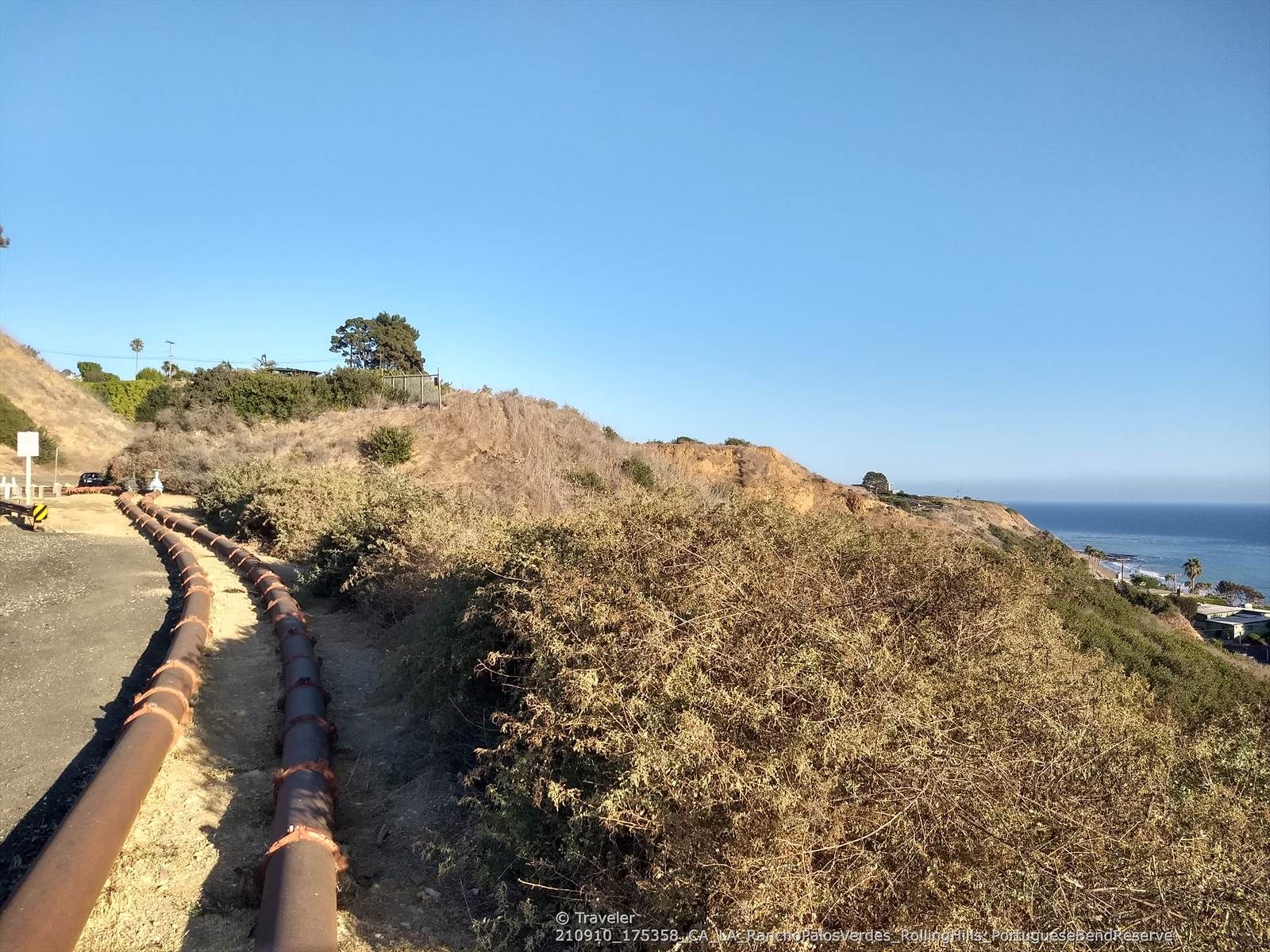 Sunny dirt path along a dry hillside overlooking the ocean. - Palos Verdes Drive Loop