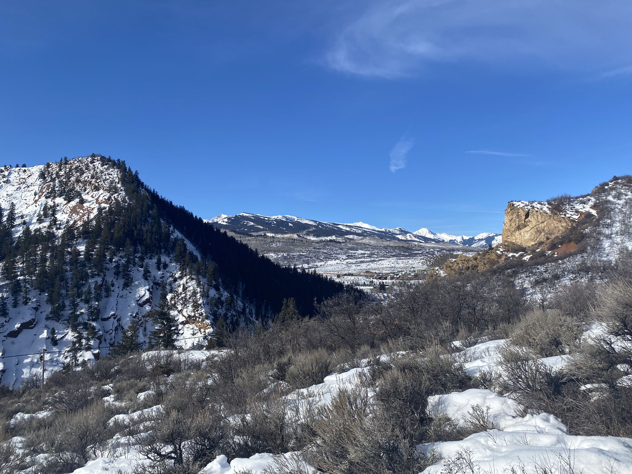 Snow-covered mountains and valley under a clear blue sky. - Sunnyside Trail