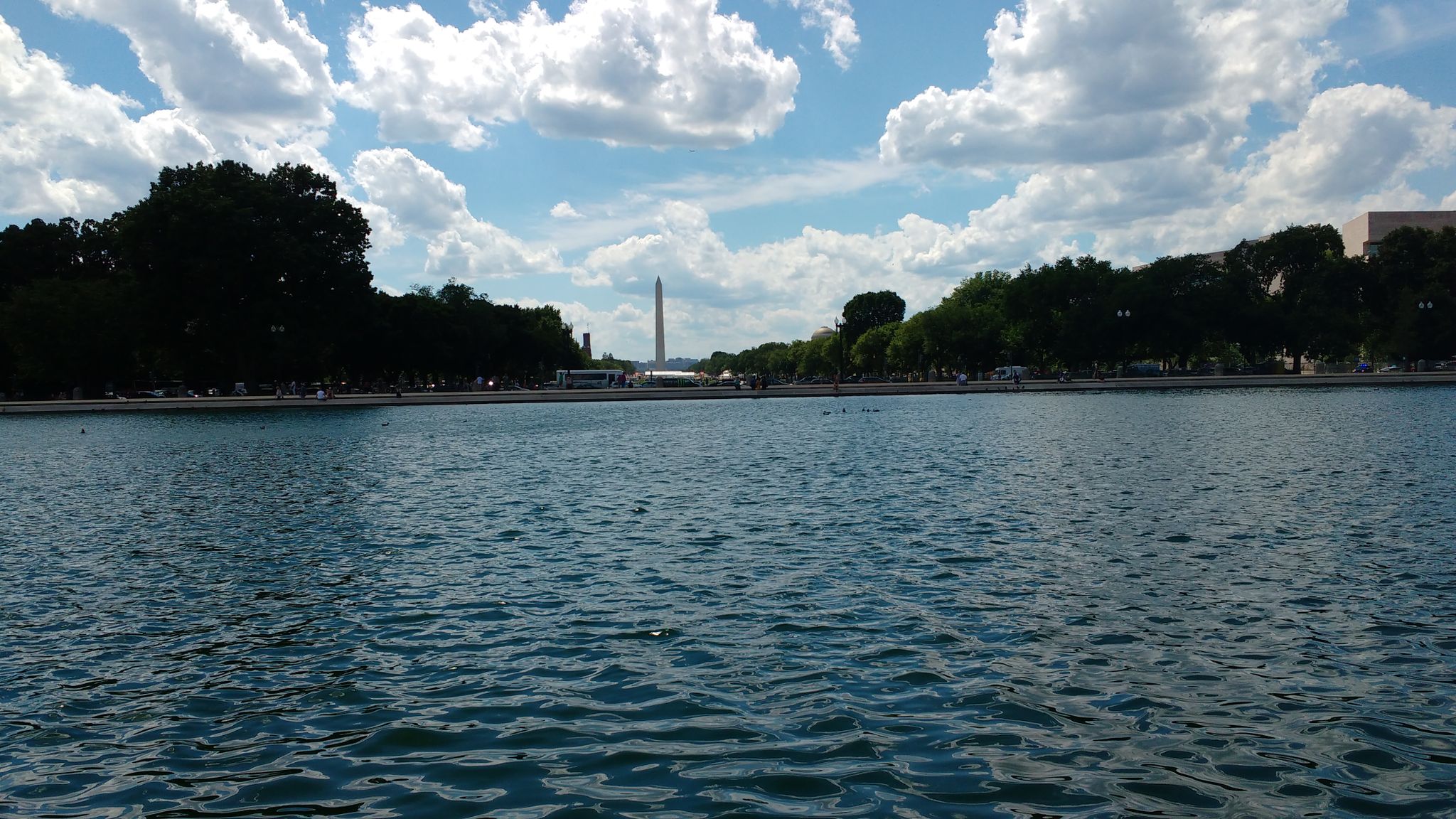 Reflecting pool with distant monument and trees under a cloudy sky. - Library of Congress loop