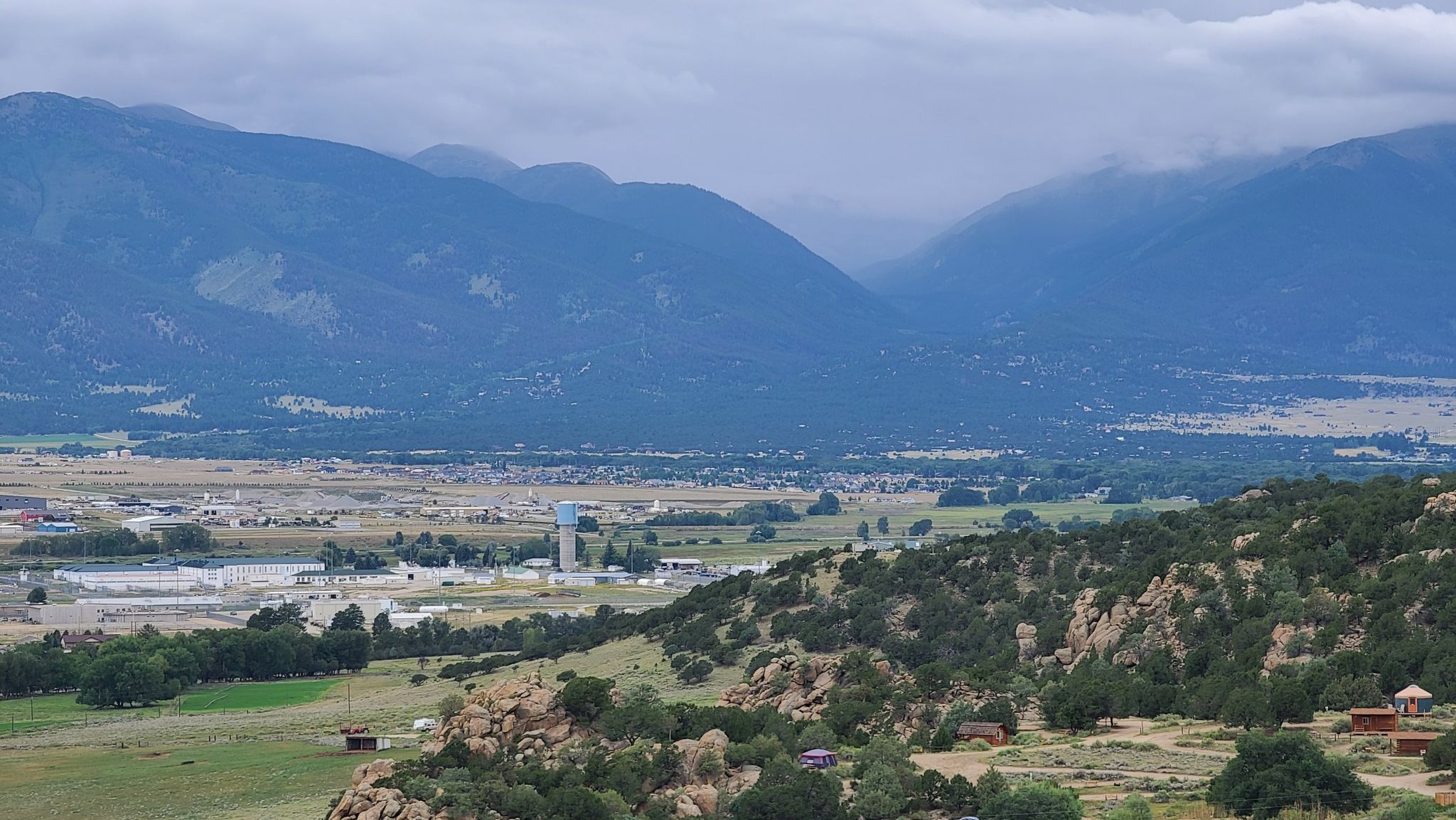 Overcast view of a valley with buildings and distant mountains. - A Fistful of Dollars and Few Dollars More Loop