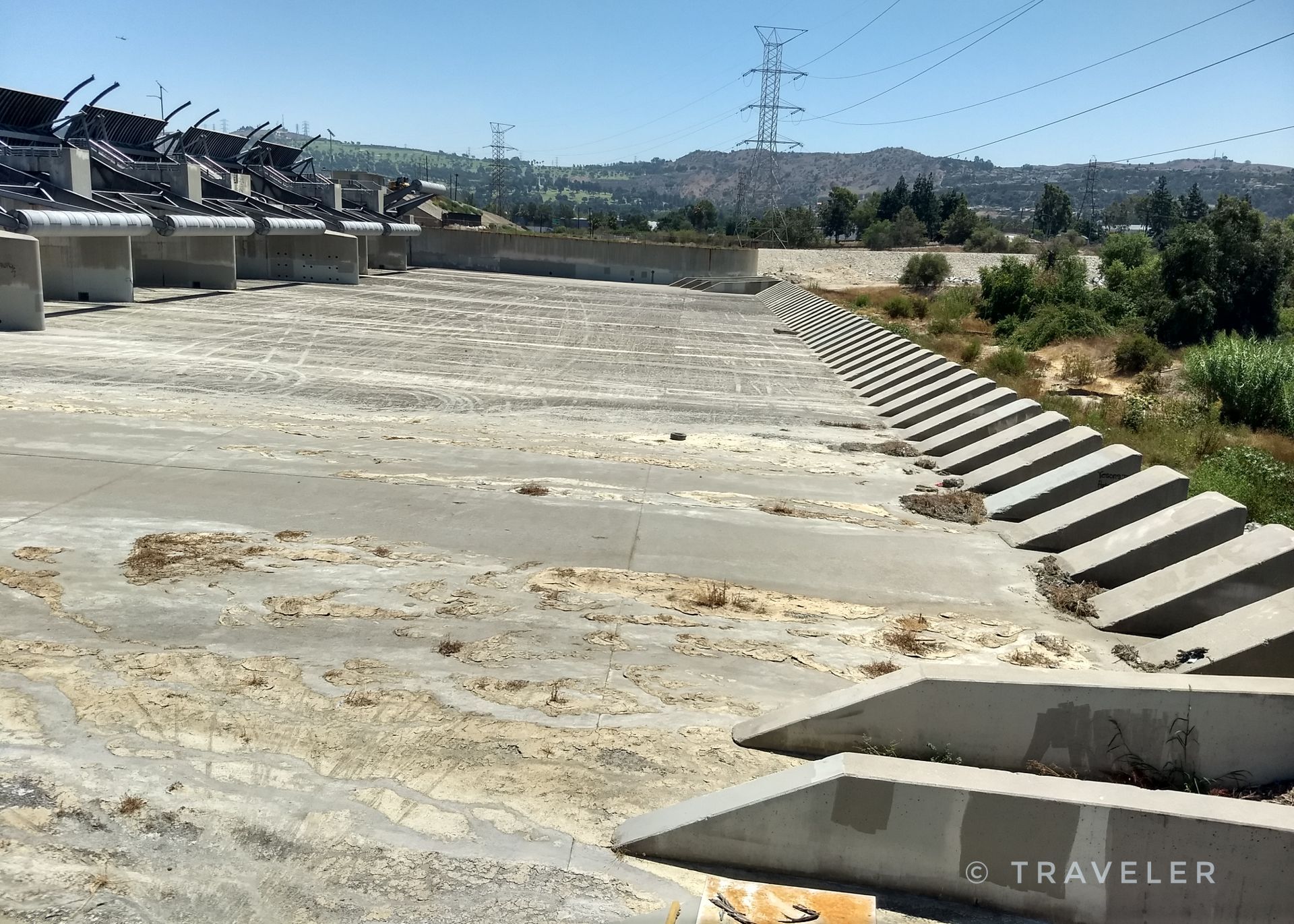 Massive concrete water control structure with steps and distant hills. - Bosque del Rio Hondo – San Gabriel River Dam loop from South Whittier