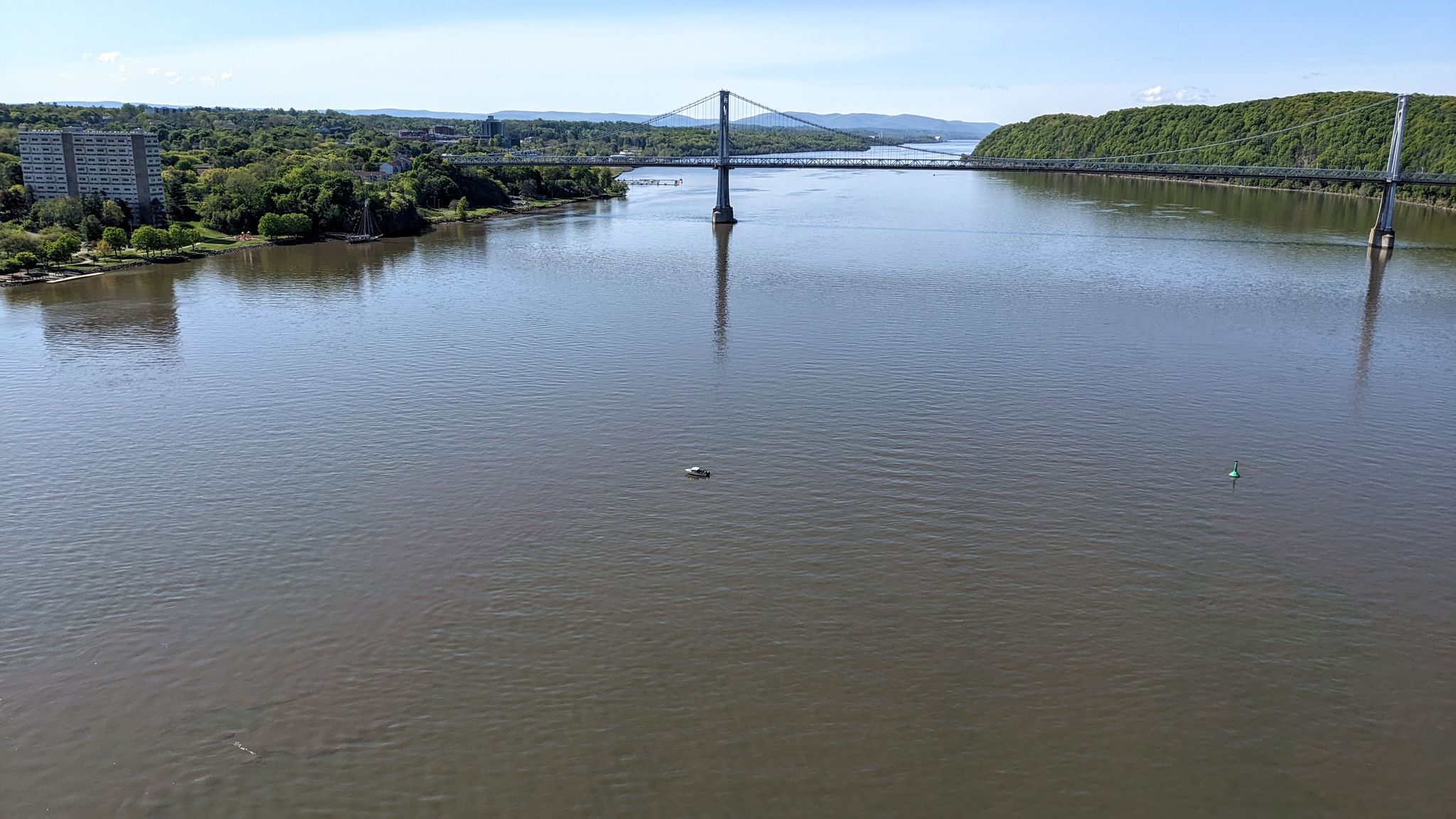 A wide river with a suspension bridge in the distance under a bright sky. - Poughkeepsie to Ashokan Reservoir loop