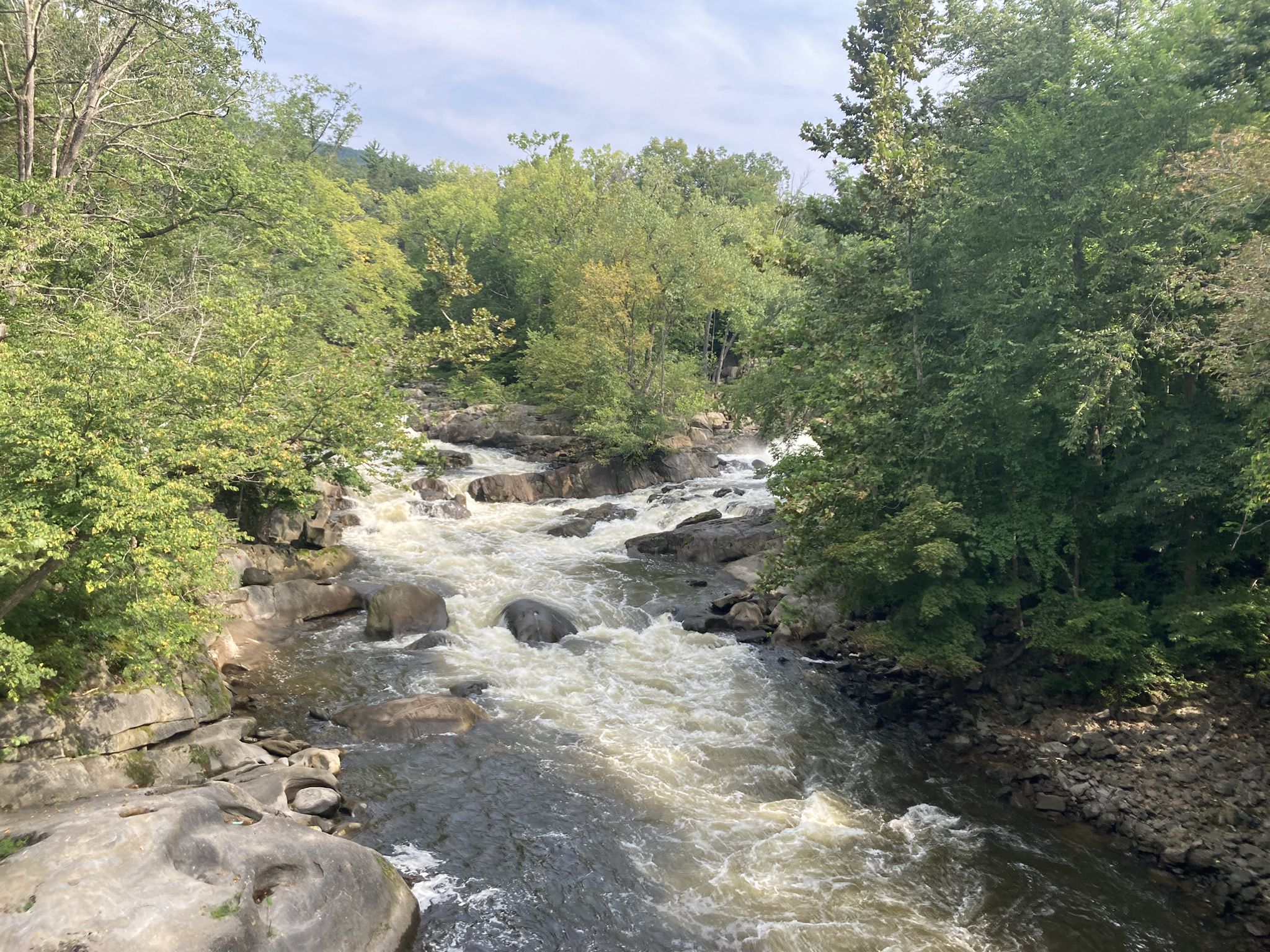 Rushing river with white water rapids flowing through a green forest. - Bulls Bridge loop from South Kent