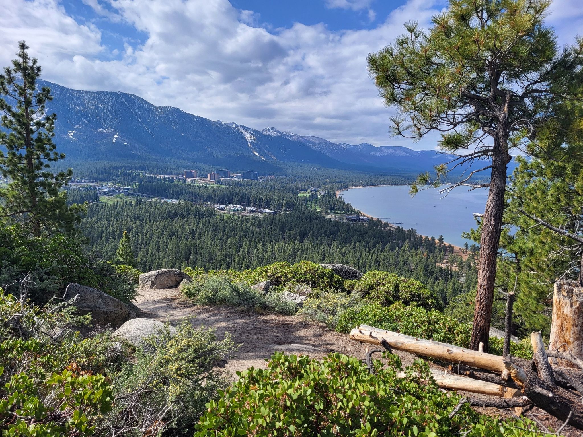 Panoramic view of a large lake, mountains, and forest under a cloudy sky. - Nevada Beach and Round Mound Trail