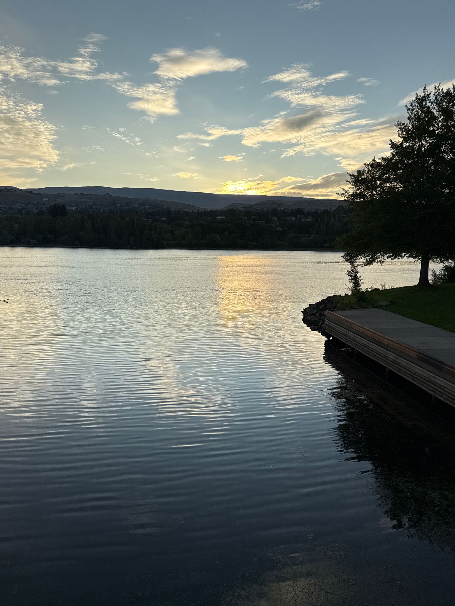 Sunset over a calm lake, reflections on water, tree and dock right. - Malaga loop