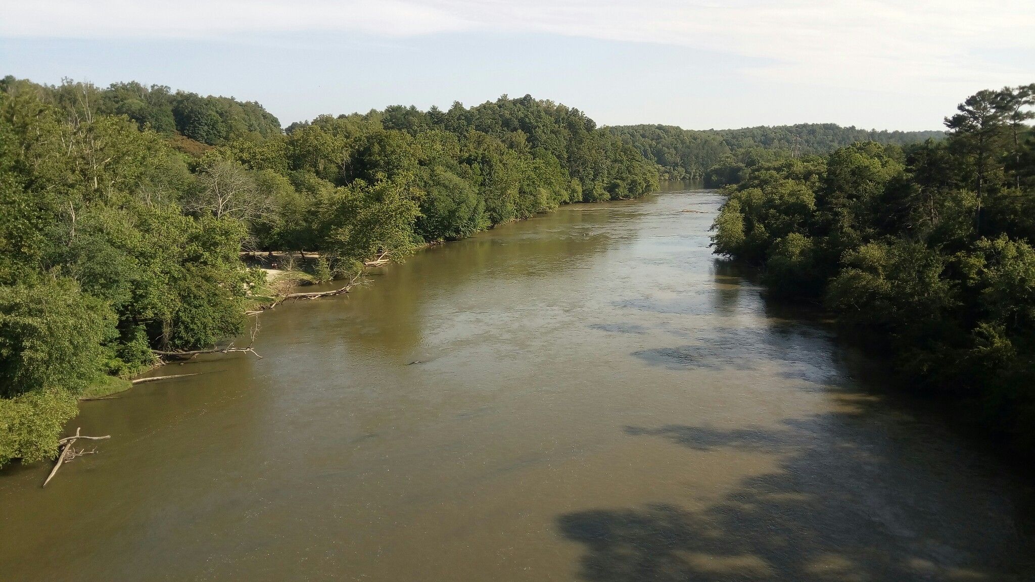 Wide, calm river flowing through a lush green forested landscape. - Warren Wilson College – Walnut Cove View loop from Warren Wilson College