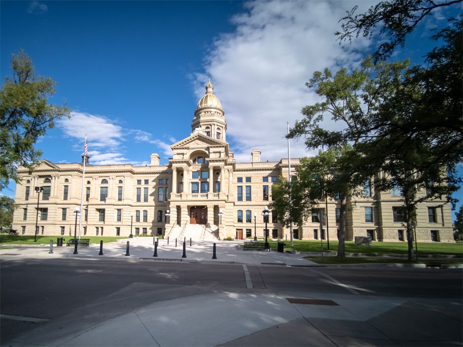 Ornate stone building with a golden dome under a bright blue sky. - Laramie to Cheyenne century ride