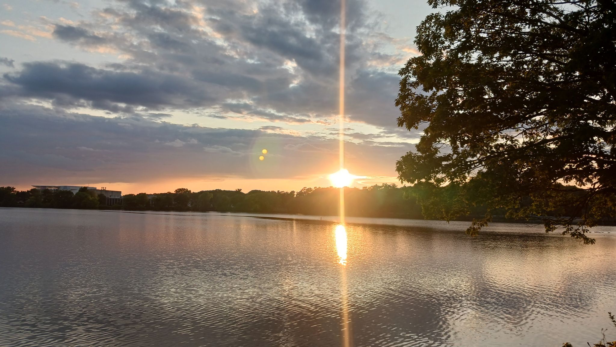 Brilliant sunset over a calm lake, with sun reflecting on the water. - Lake Quannapowitt – Lake Quannapowitt loop from Wakefield