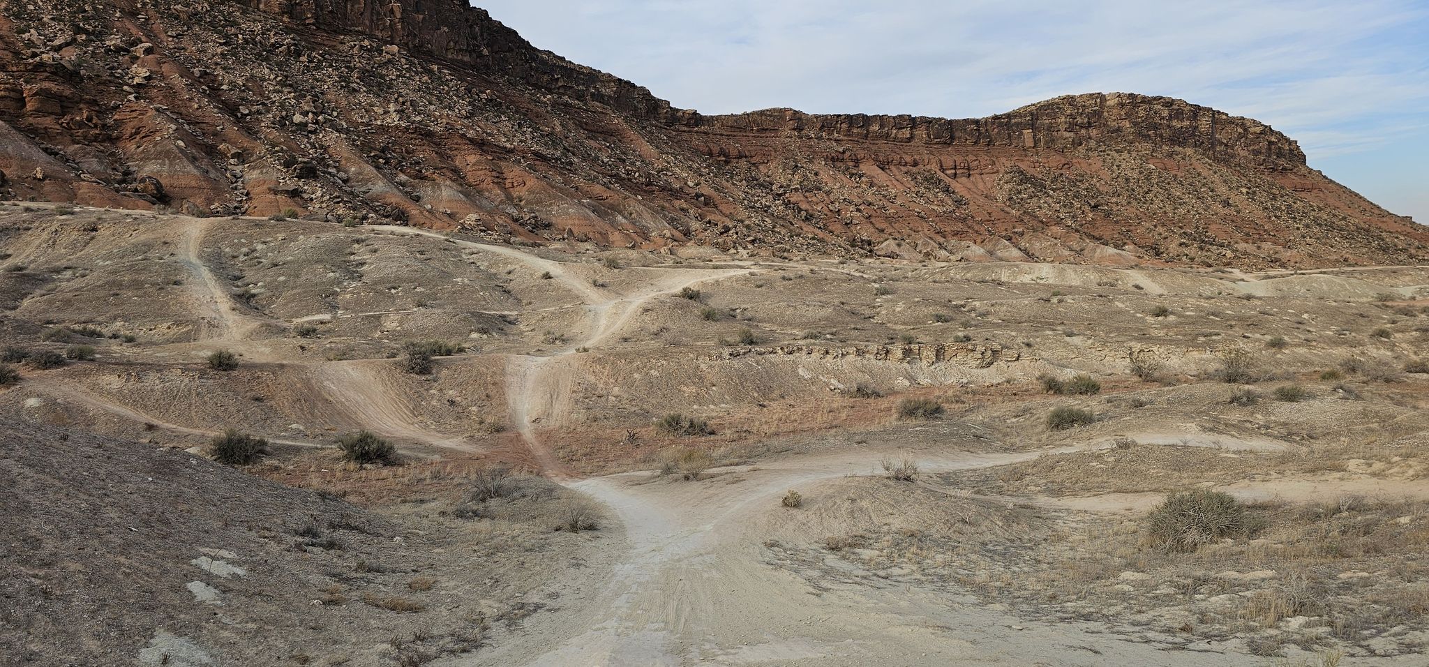 Multiple dirt roads crisscross a dry, hilly desert landscape with rocky mountains. - Bloomington Park – Bearclaw Poppy Trail loop from Hidden Valley