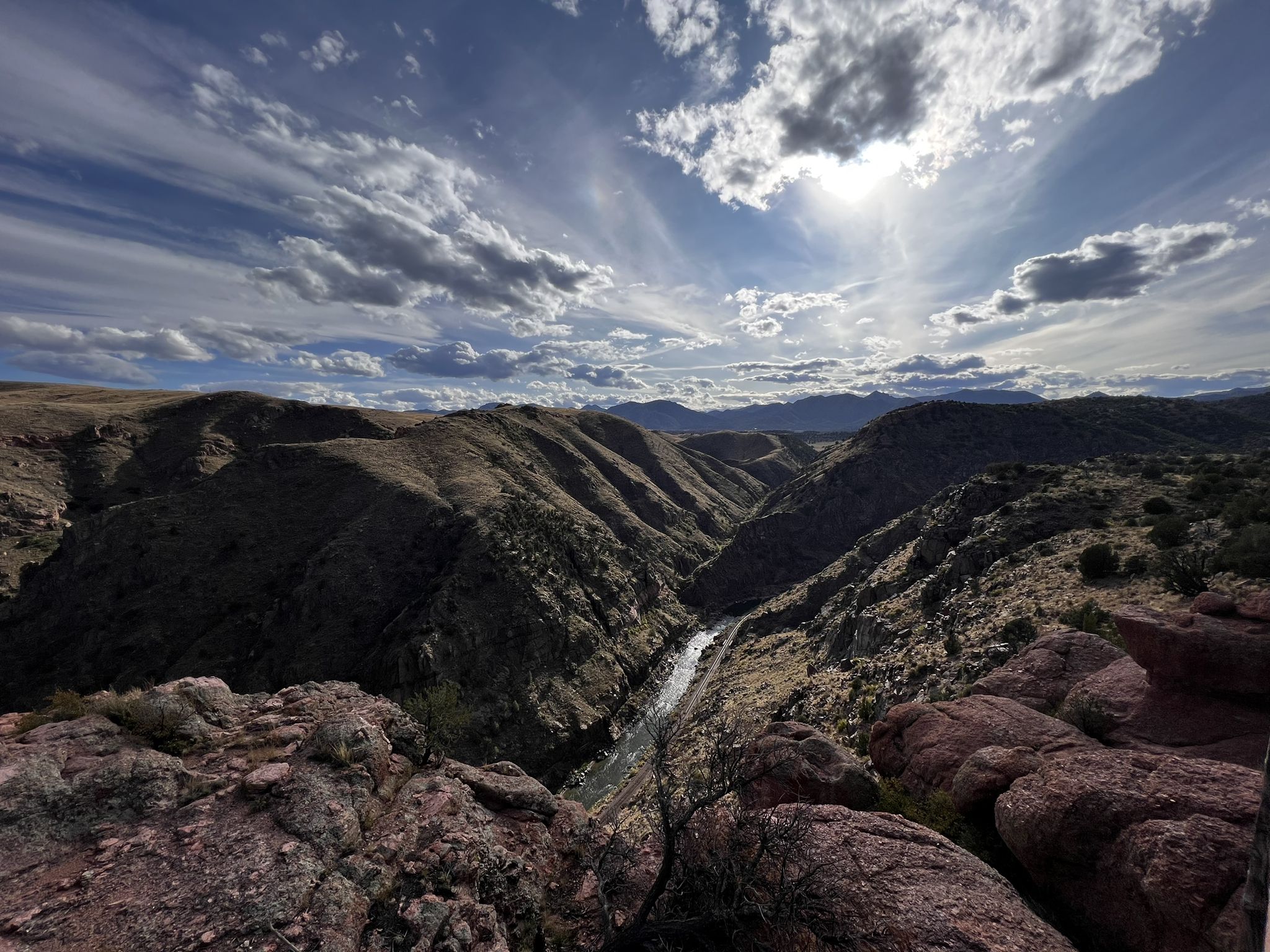 Panoramic view of a rugged canyon with a river under a dramatic, sunny sky. - Point Alta Vista and One Track Mind Loop