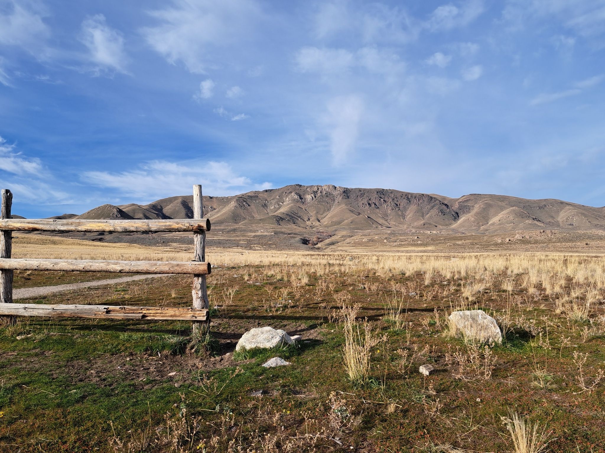 Wooden fence in dry field with large mountains under a bright sky. - Mountain View and Frary Interpretive Trail Loop