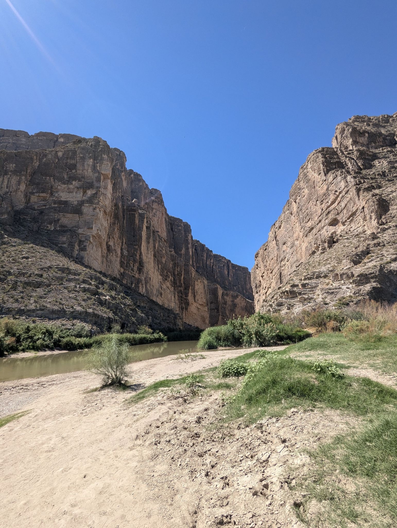River winding through a deep canyon with towering rock walls. - Ross Maxwell Scenic Drive