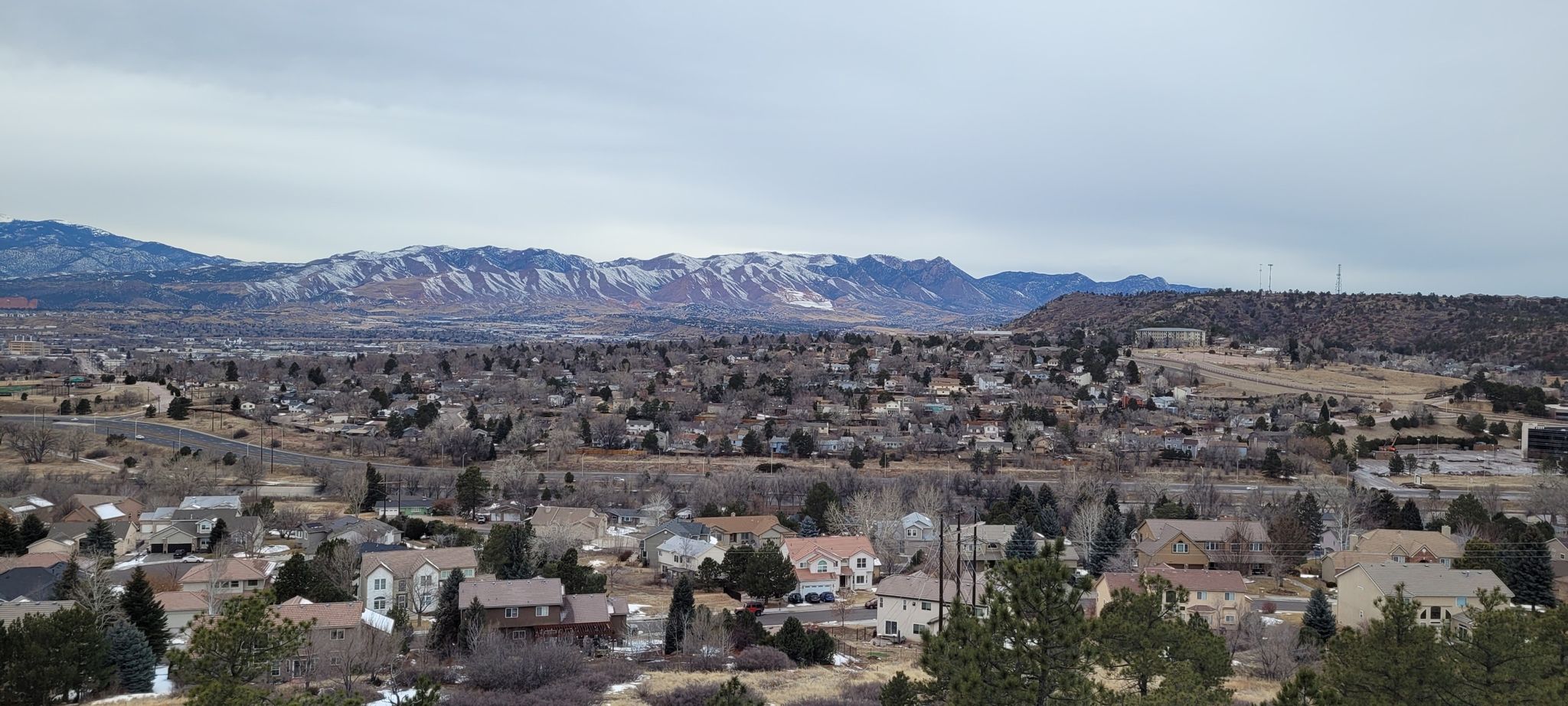 Overcast panoramic view of a town with distant snow-dusted mountains. - Templeton, Mesa and Yucca Trail Loop
