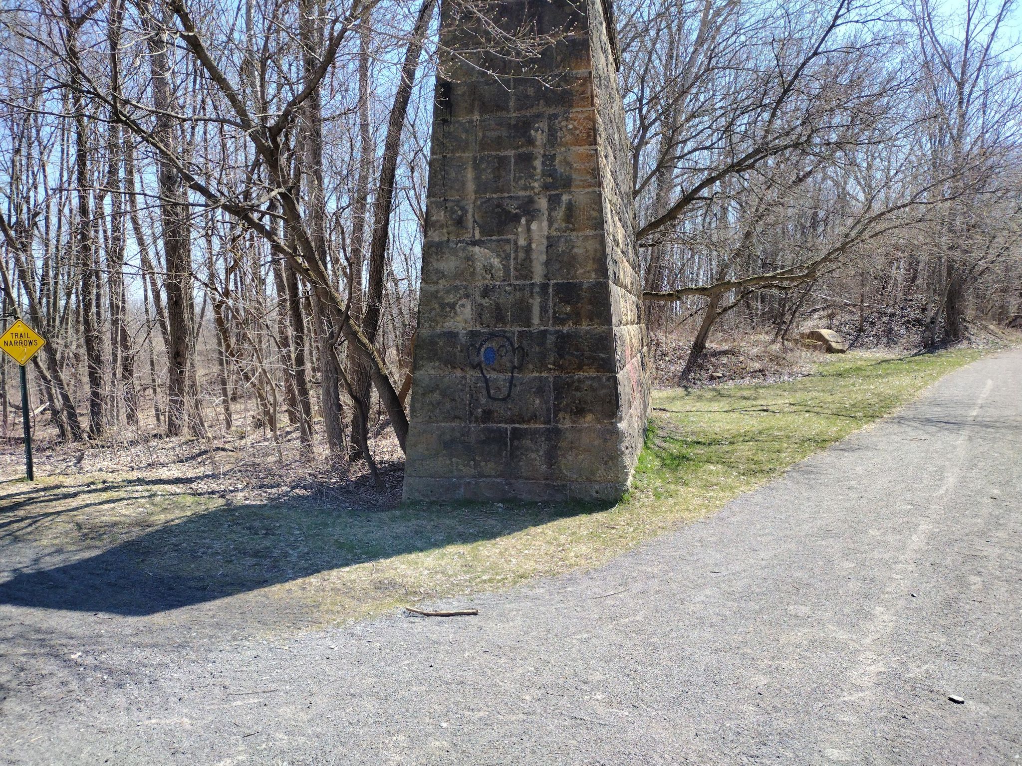 Large stone pillar next to a gravel path in a bare winter forest. - Wadsworth Junction loop from Scottsville