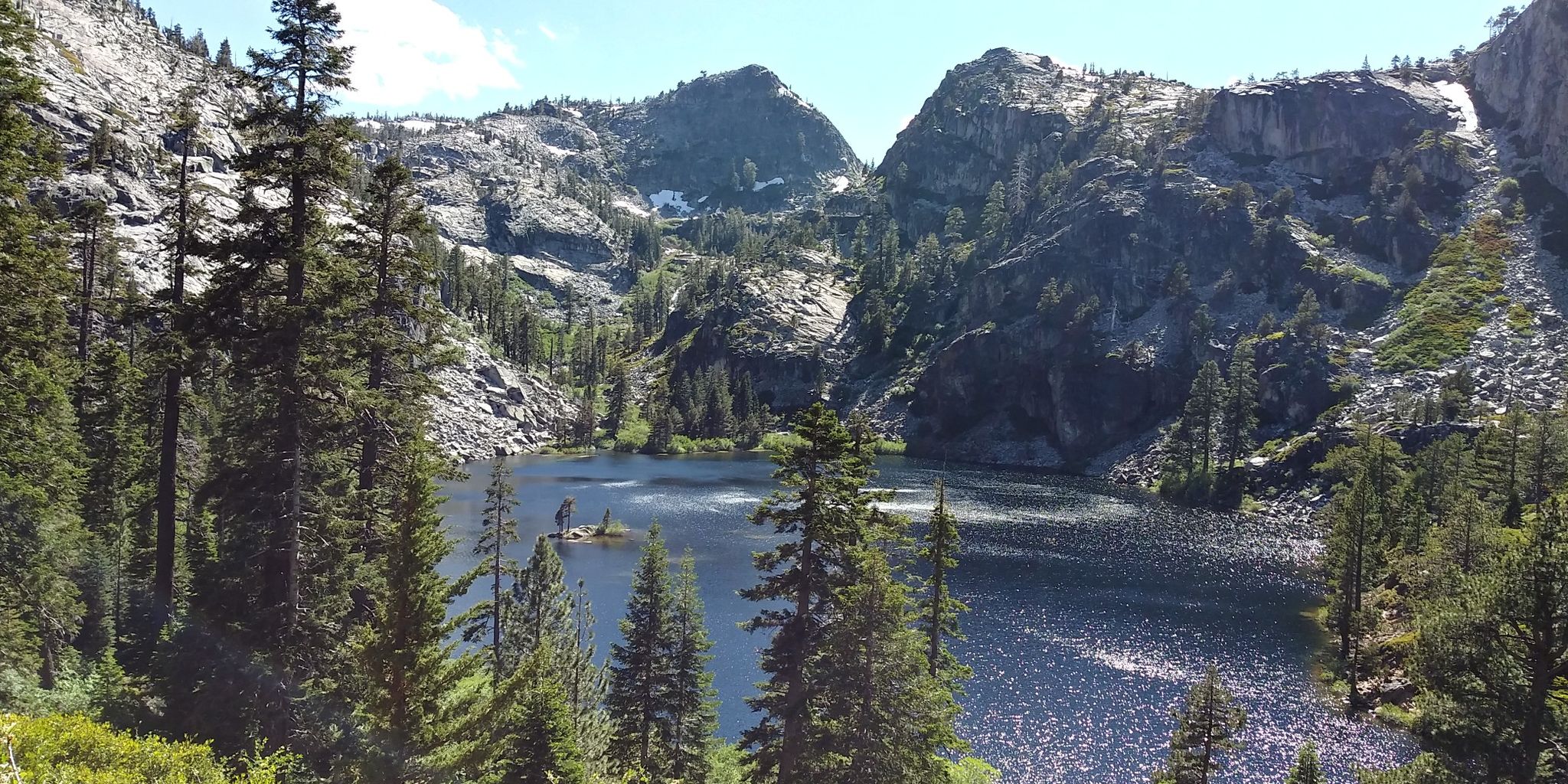 Serene lake nestled among tall pine trees and steep rocky mountains. - Eagle Falls Trailhead to Middle Velma, Dicks, and Susie Lake