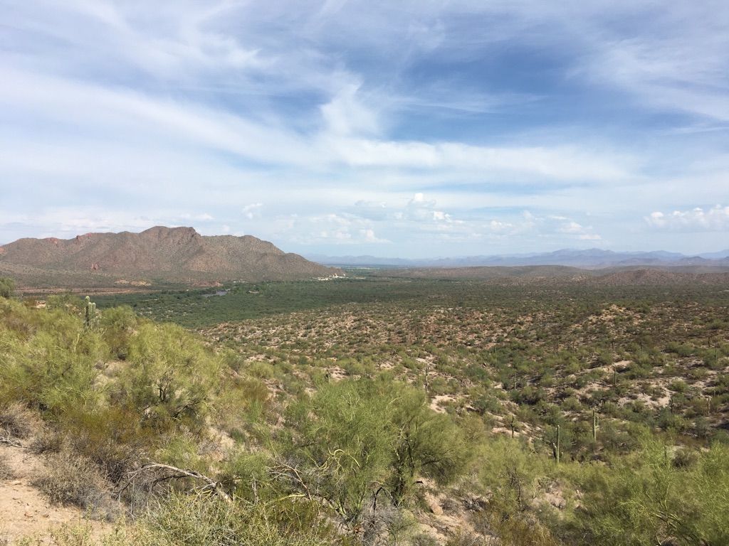 Vast desert landscape with mountains under a partly cloudy sky. - Alpe d‘Huez Trail – Wild Horse Trail loop from Power Road Park and Ride