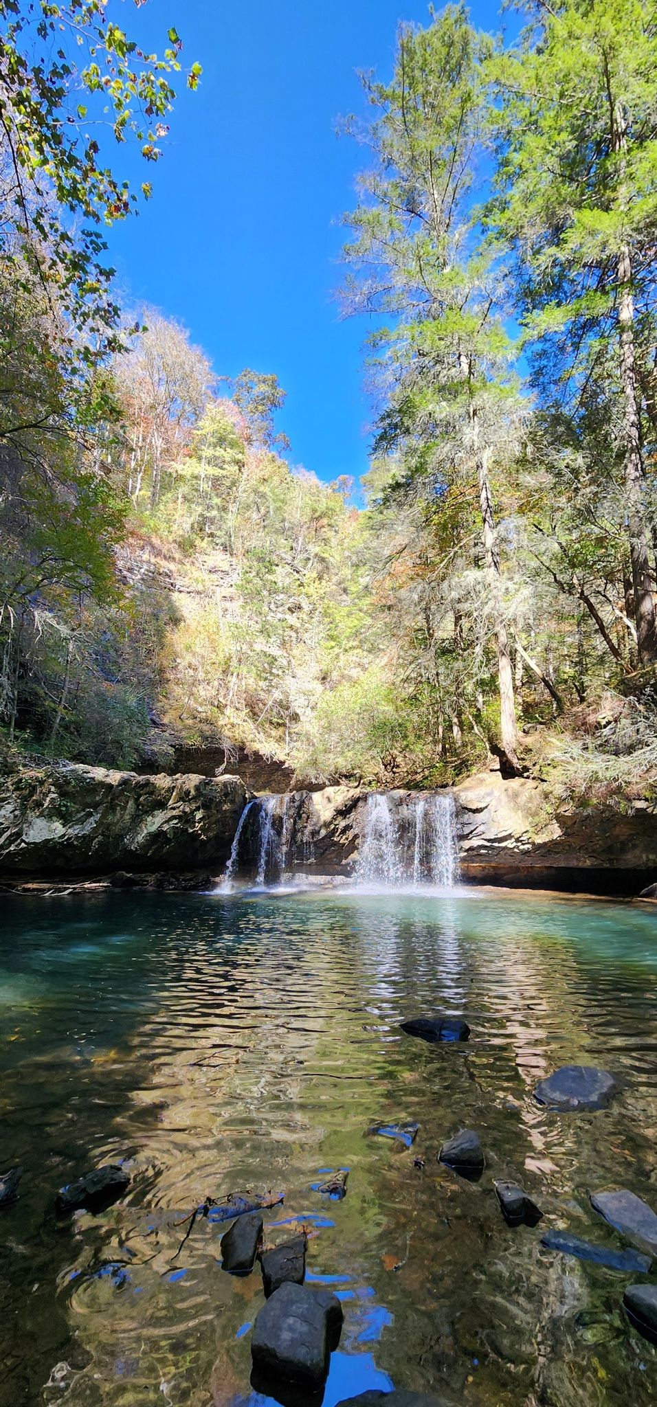 Waterfall cascading into a clear pool under a bright blue sky. - Grundy State Forest loop from Tracy City