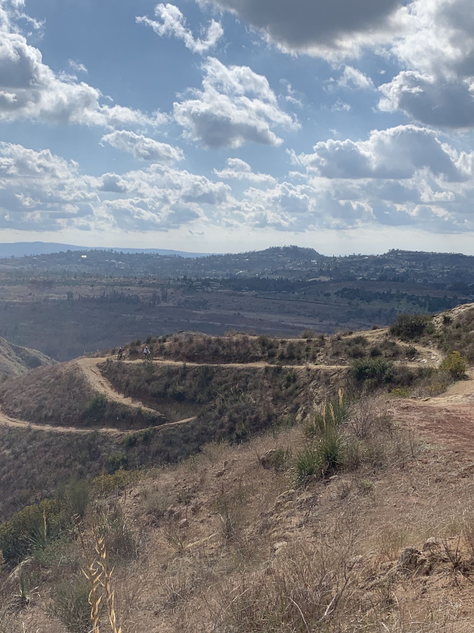Winding dirt trails on dry, brush-covered hills under a cloudy sky. - Robbers Peak loop via Santiago Creek Trail