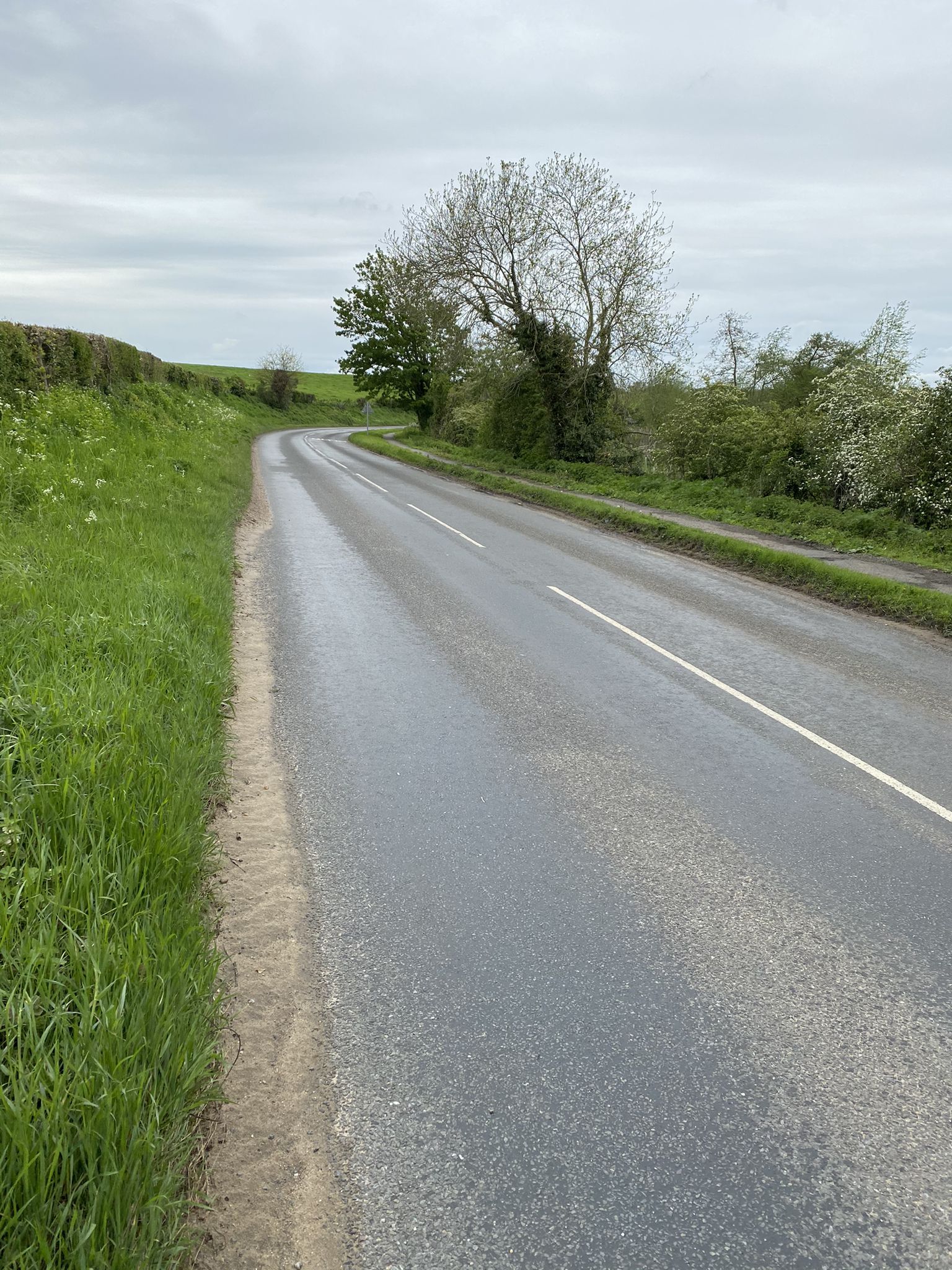 either turn left onto main road, or cross over and use the pathway back towards Home