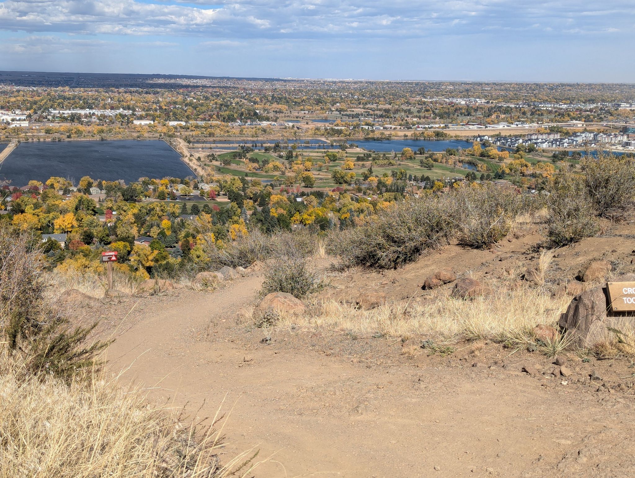 Elevated view of a landscape with lakes, autumn trees, and distant urban development. - Ancient Palms and Basalt Cap Loop