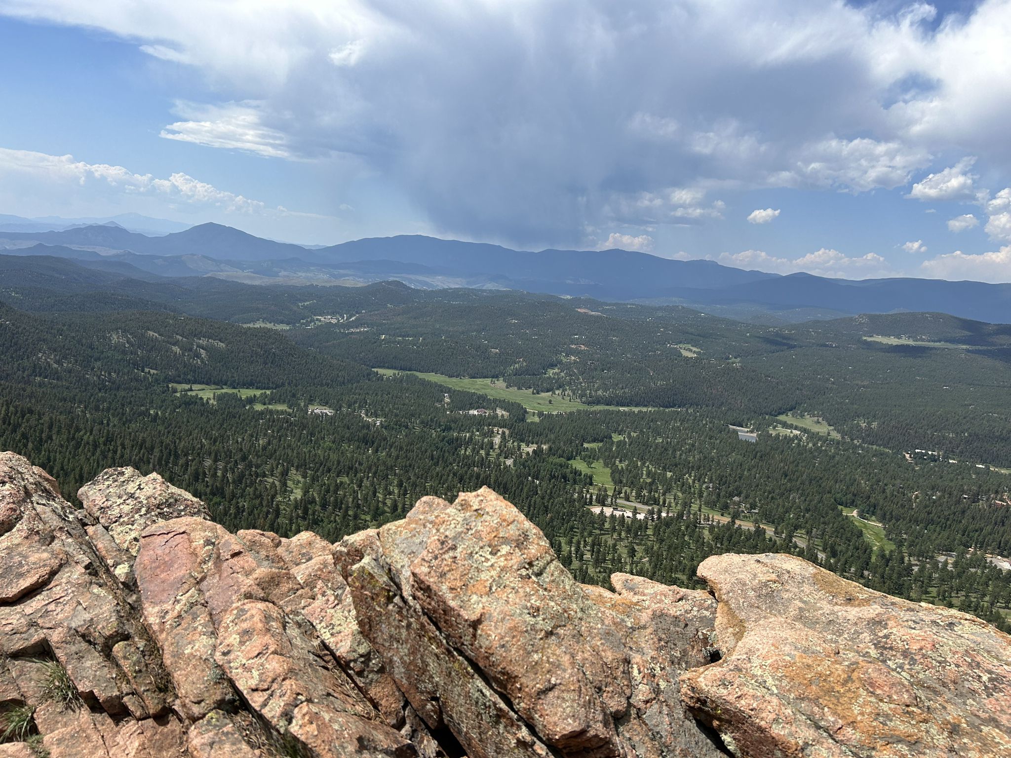 Panoramic view from a rocky cliff overlooking a vast forested valley under clouds. - Staunton State Park loop