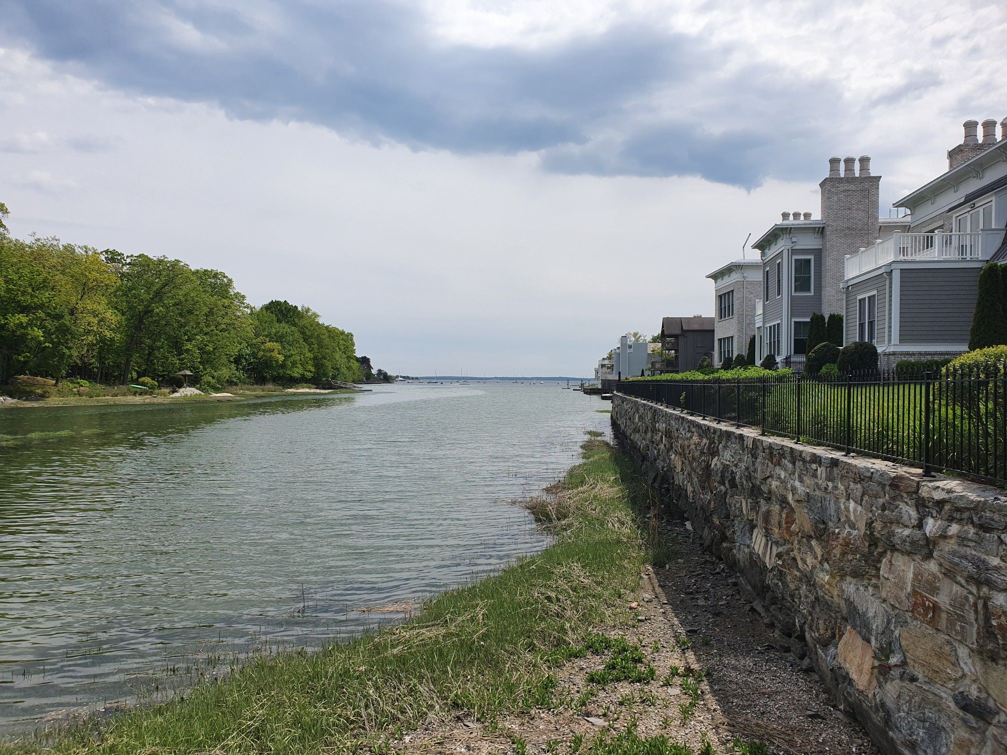 River flowing towards the ocean, with houses and trees under cloudy skies. - Bruce Park loop