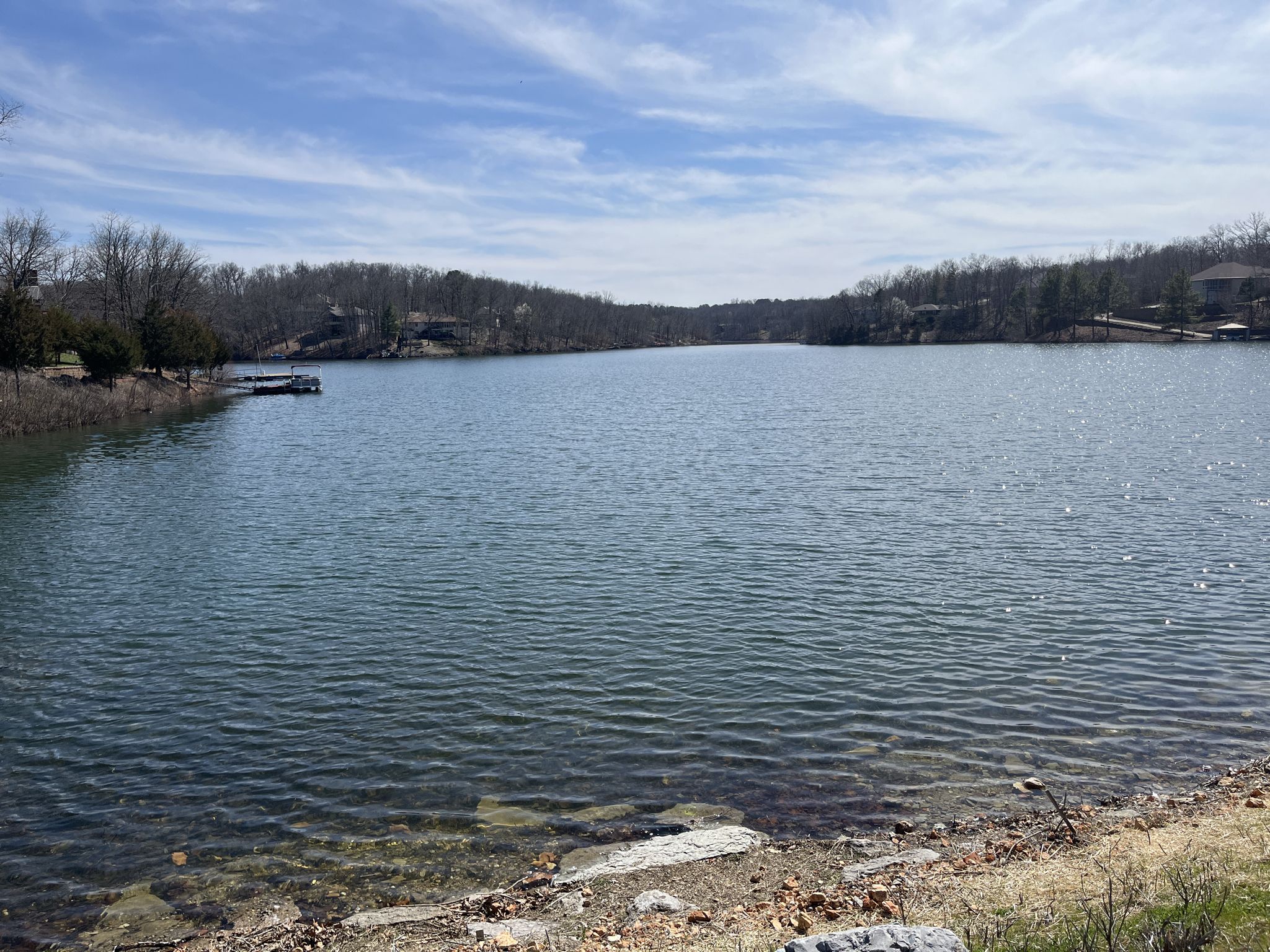 Wide lake with forested shores under a partly cloudy sky. - The Gear Garden Beer Garden – Green Bike Tower loop from Lake Ann Lot