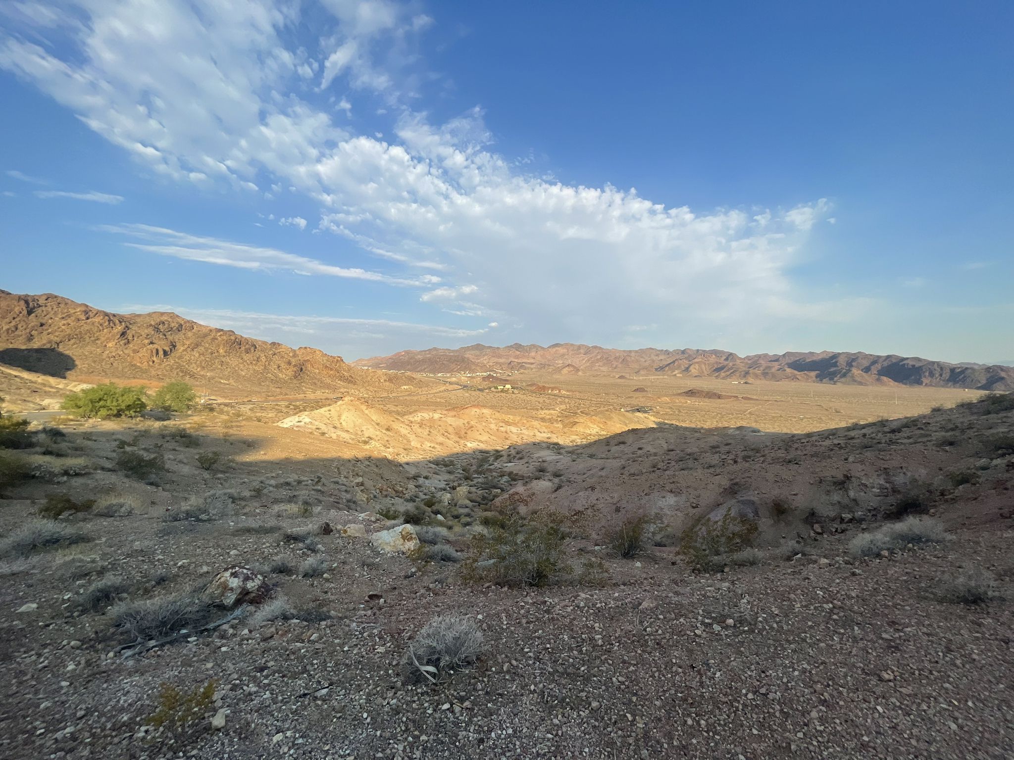 Arid desert valley with distant mountains under a partly cloudy sky. - Hoover Dam Lodge Trail