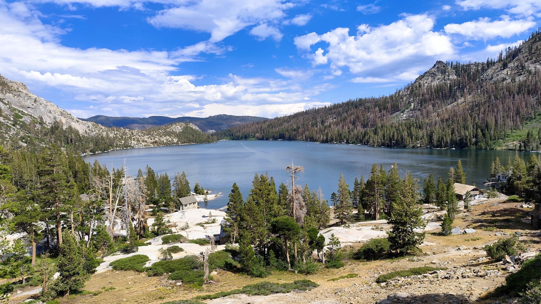 Large lake surrounded by forested mountains under a partly cloudy sky. - Pacific Crest Trail: Echo Lake to Lake of the Woods