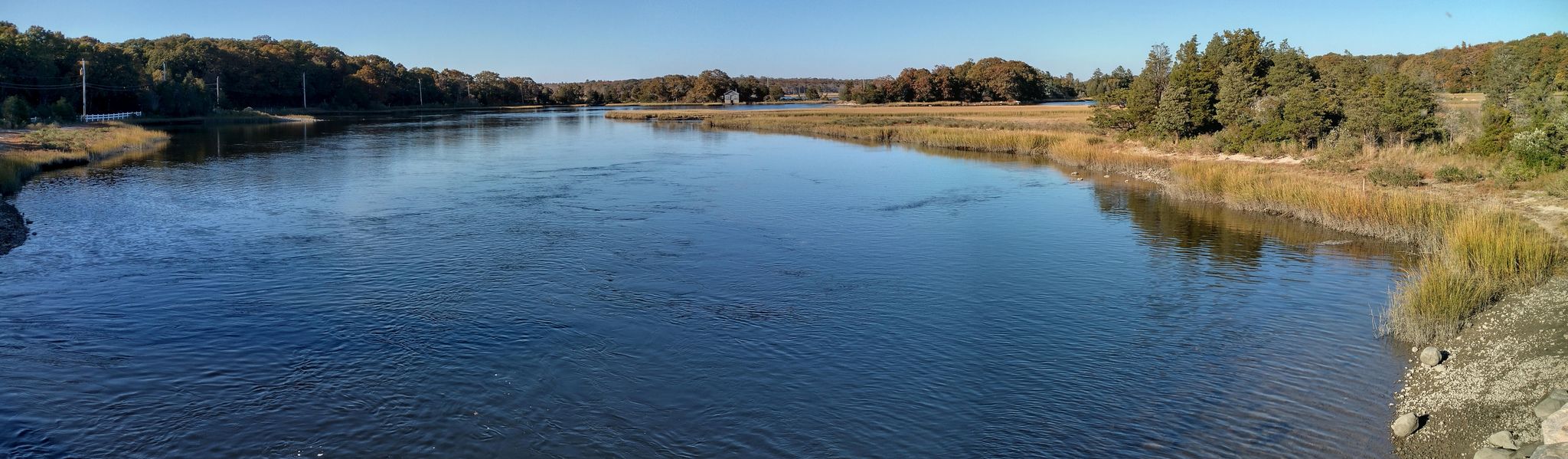 Wide river flowing between green and golden marshlands, under a clear blue sky. - Apponagansett Beach – Demarest Lloyd State Park loop from Palmer Island Light