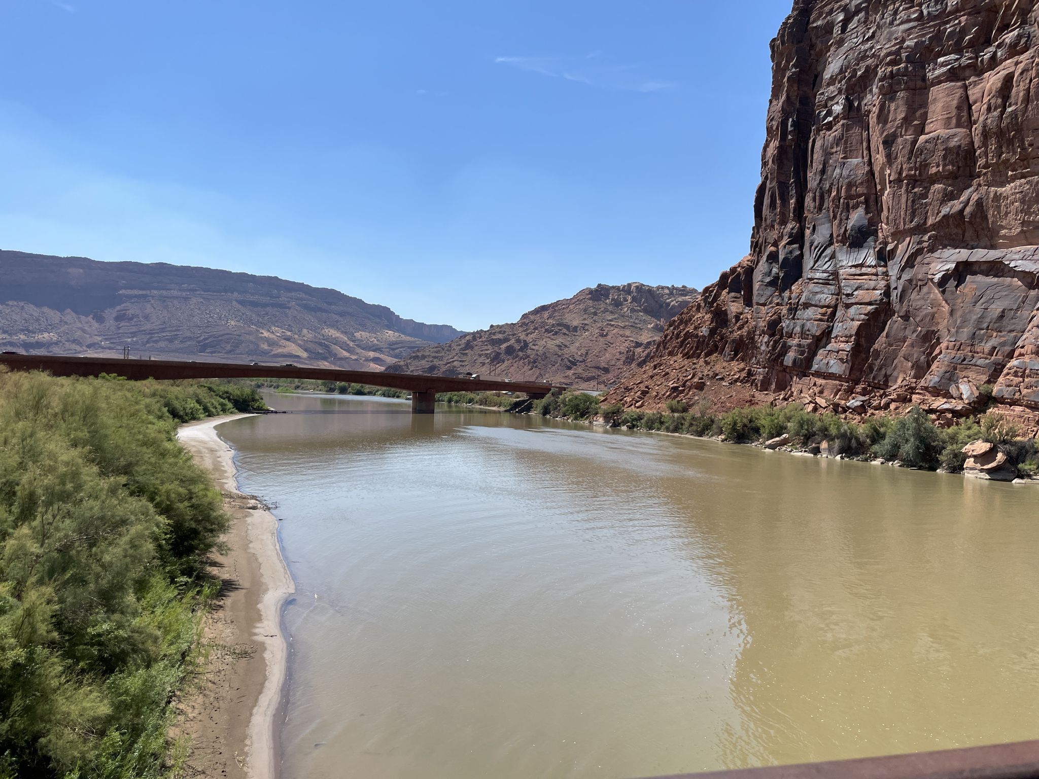 Wide river flowing through a desert canyon, distant bridge, bright daylight. - Moab Canyon Pathway – Bridge over the Colorado River loop from Element/WorldMark