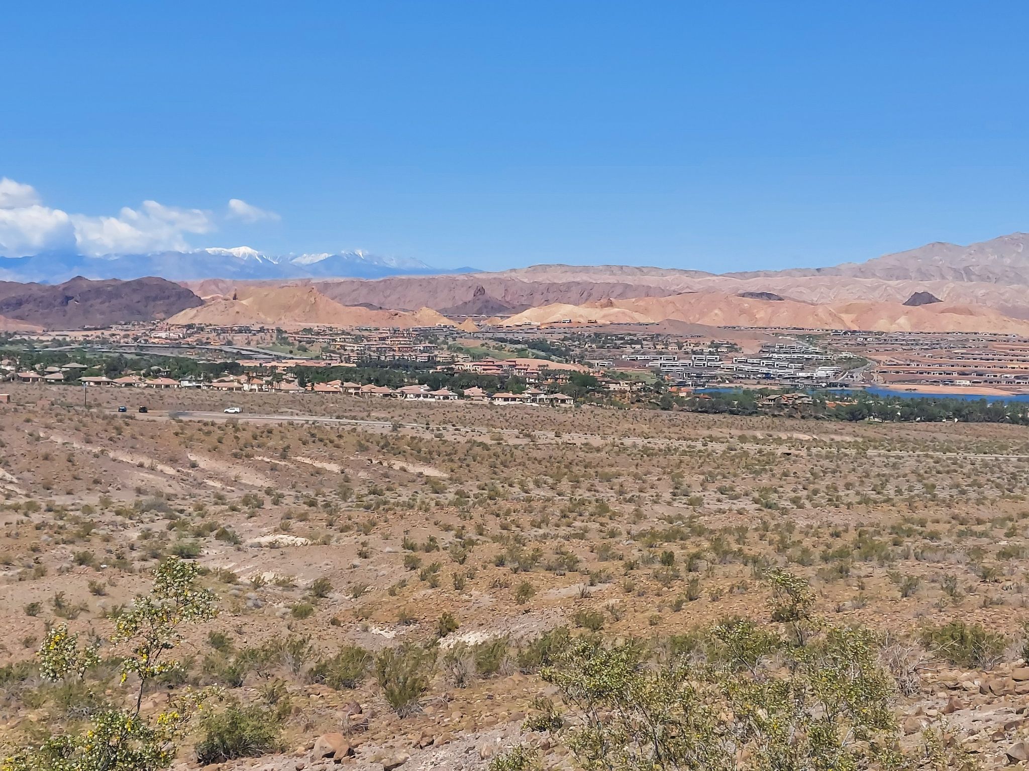 Wide desert valley with a town, distant mountains, and a clear blue sky. - Bike loop from Boulder Beach Maintenance Yard