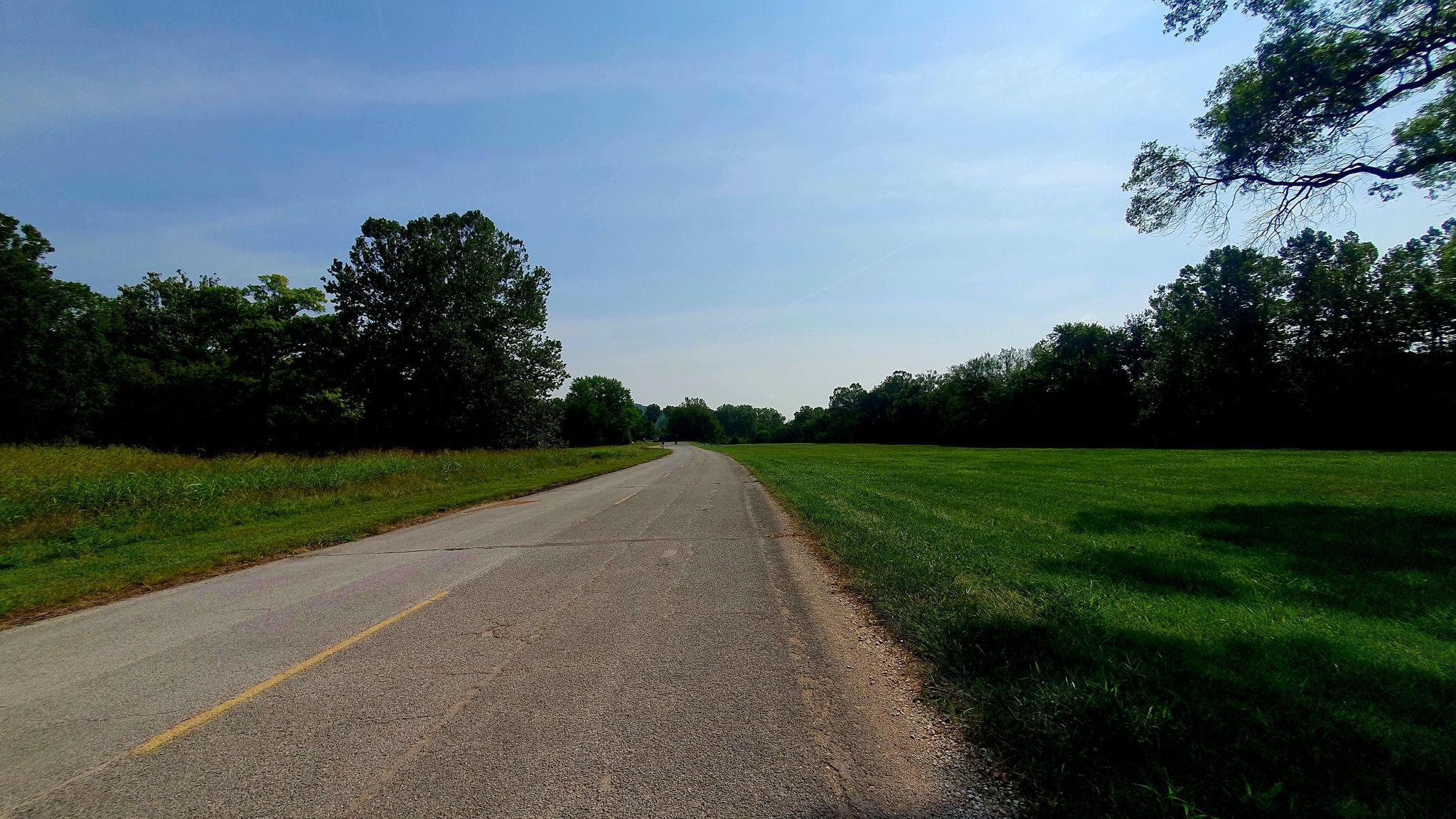Paved road stretching through green fields under a bright blue sky. - Downtown Eureka loop from Eureka
