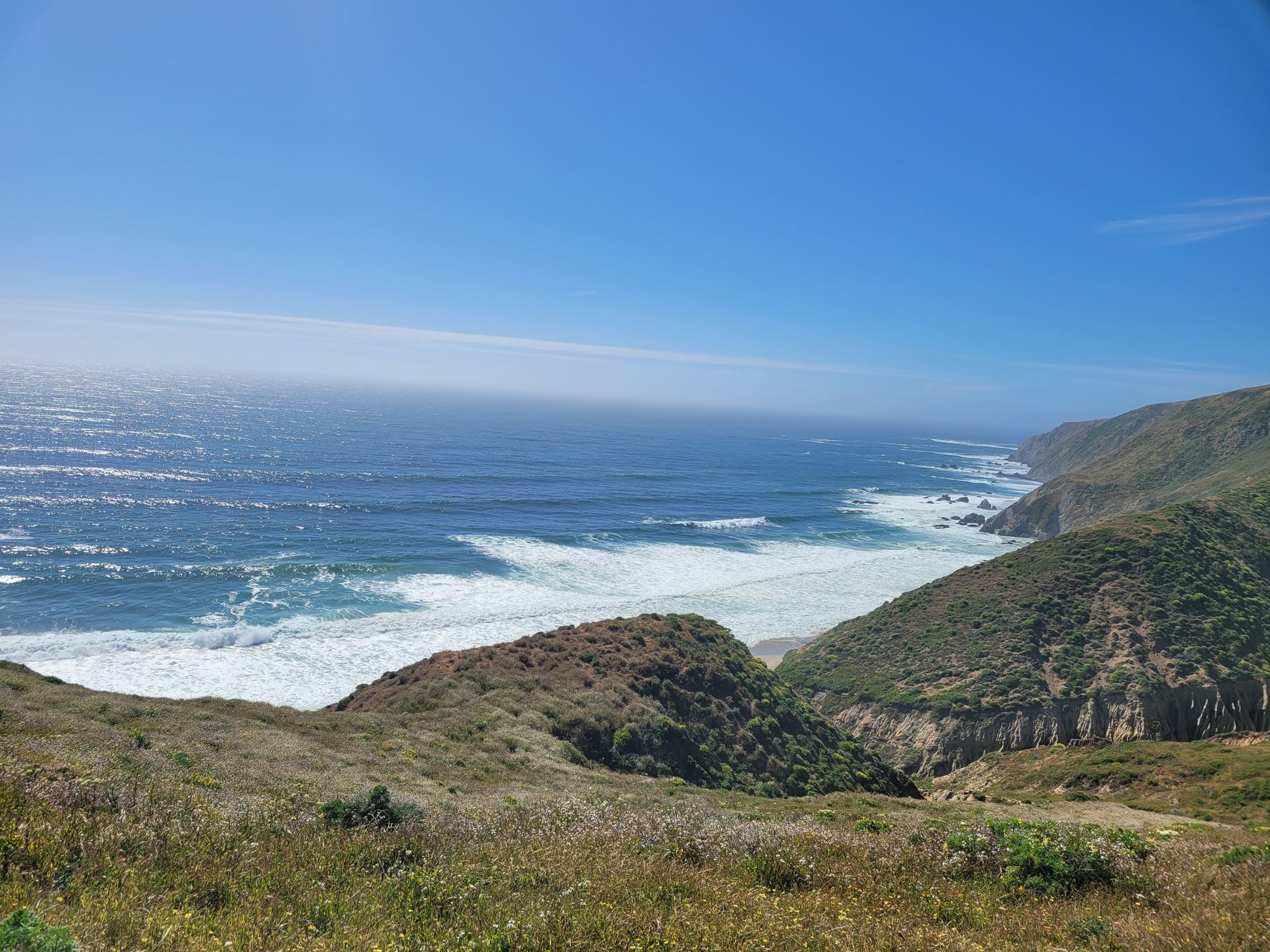 Rugged, brush-covered hillsides descend to a vast blue ocean with powerful white waves. - Pierce Point Ranch – Tomales Point Trail loop from Pierce Point parking lot
