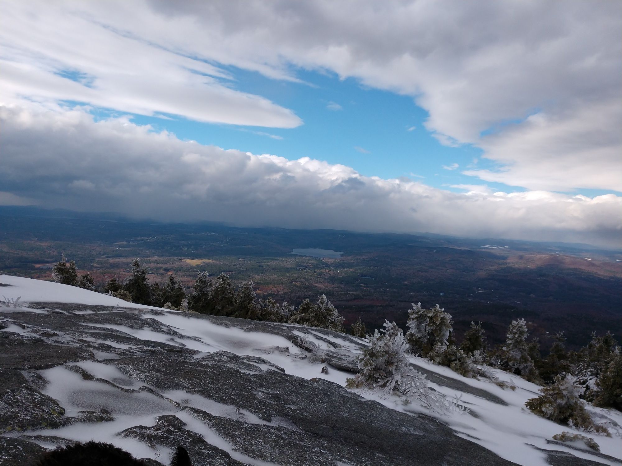 Snow-dusted rocky mountain slope overlooking a valley under a cloudy sky. - Mount Kearsarge via Winslow and Barlow Trail Loop