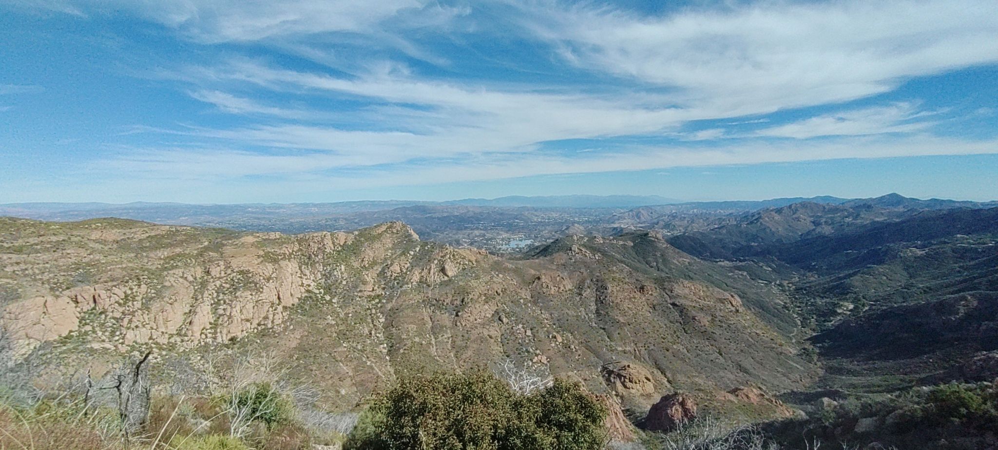 Panoramic view of vast rugged mountains and valleys under a bright blue sky. - Mishe Mokwa to Tri-Peaks and Sandstone Peak – Santa Monica Mountains National Recreation Area