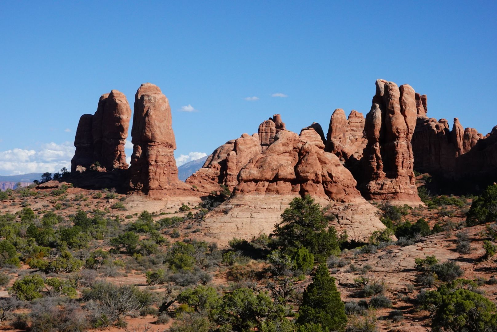 Striking red rock formations resembling towers rise from a desert landscape. - Courthouse Wash – Bridge over the Colorado River loop from Holiday Inn