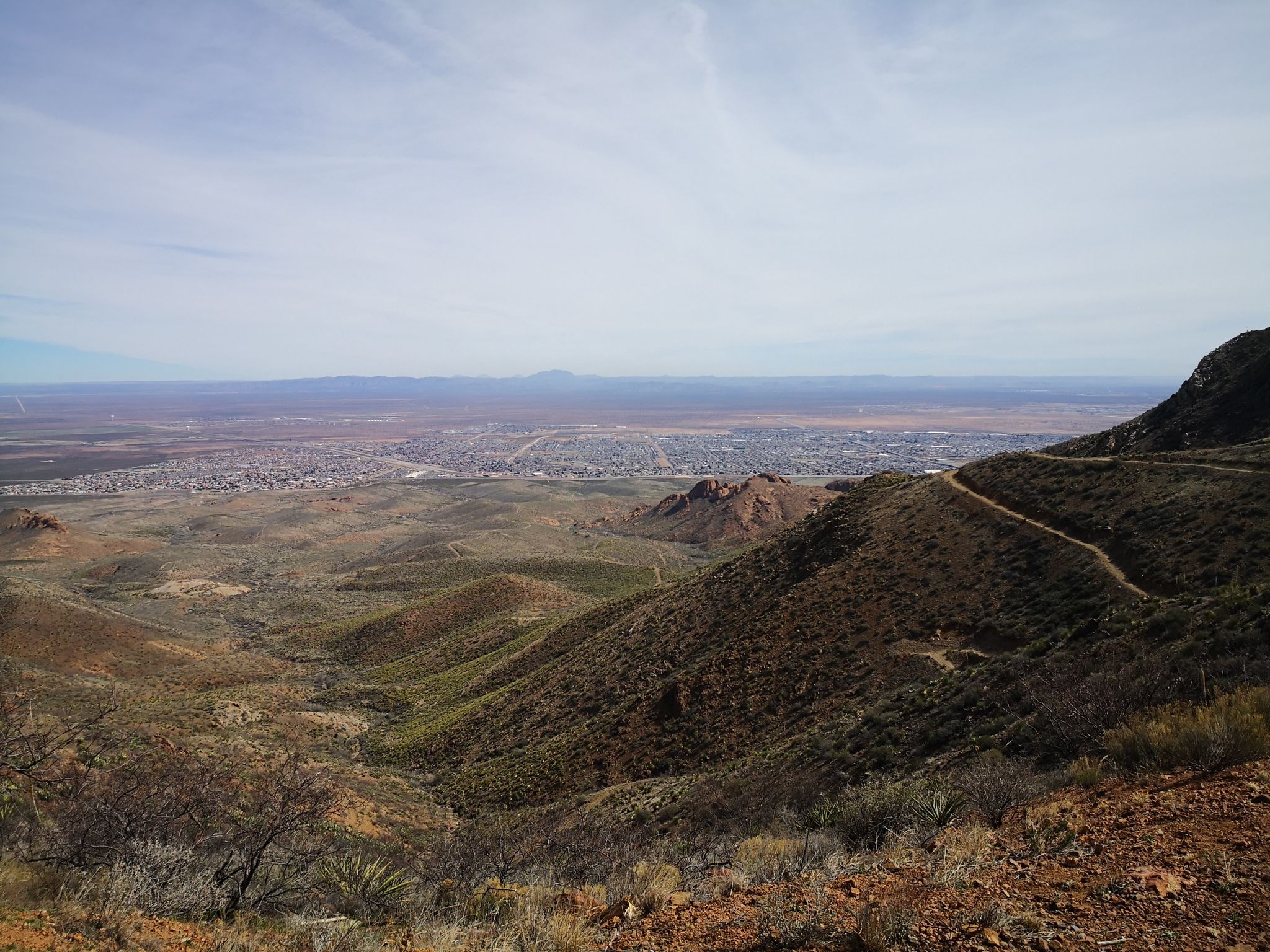 High angle view of a desert valley with a city in the distance. - Mundy's Gap and Agave Loop Trail