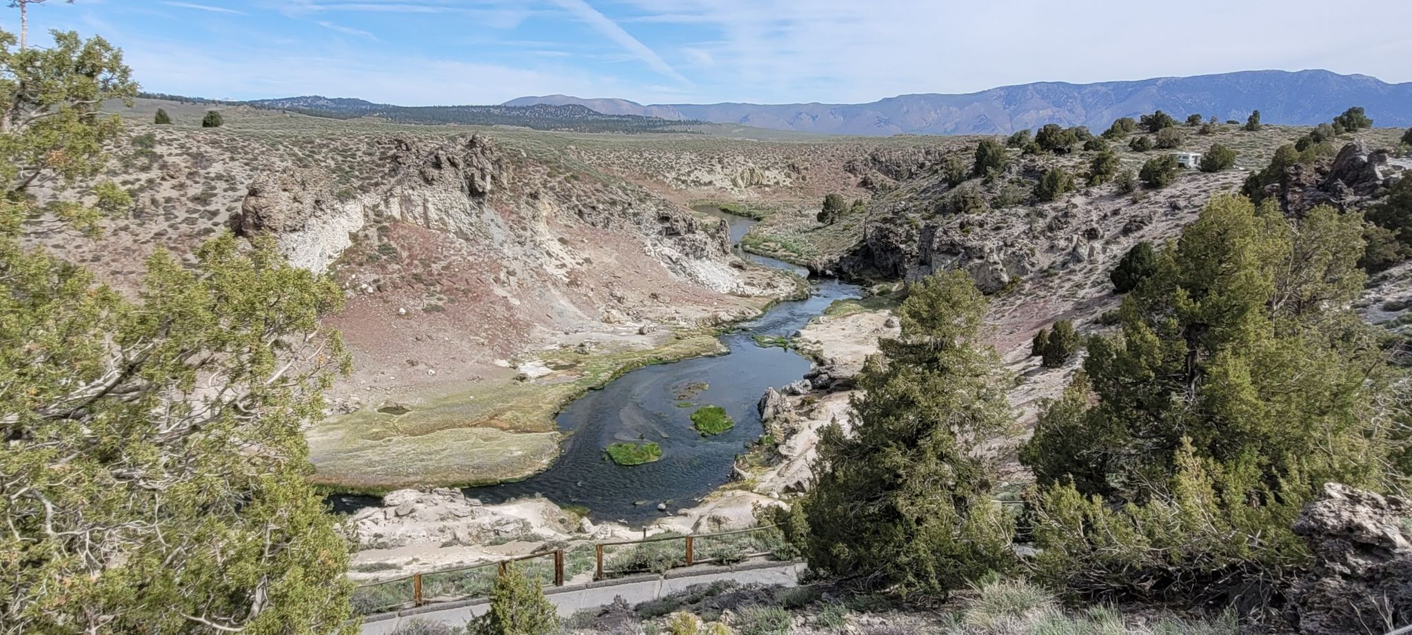River flowing through a dry, rocky canyon with distant mountains. - Hot Creek Canyon Overlook – Shepherd Hot Springs loop from Boiling Lake