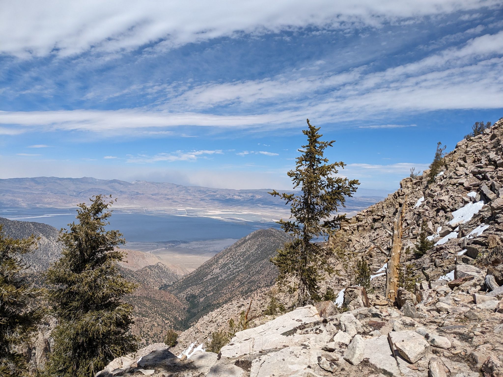 Panoramic view from a rocky mountain, overlooking a vast valley and distant lake. - Nice campsite – Diaz Creek water source loop from Death Canyon
