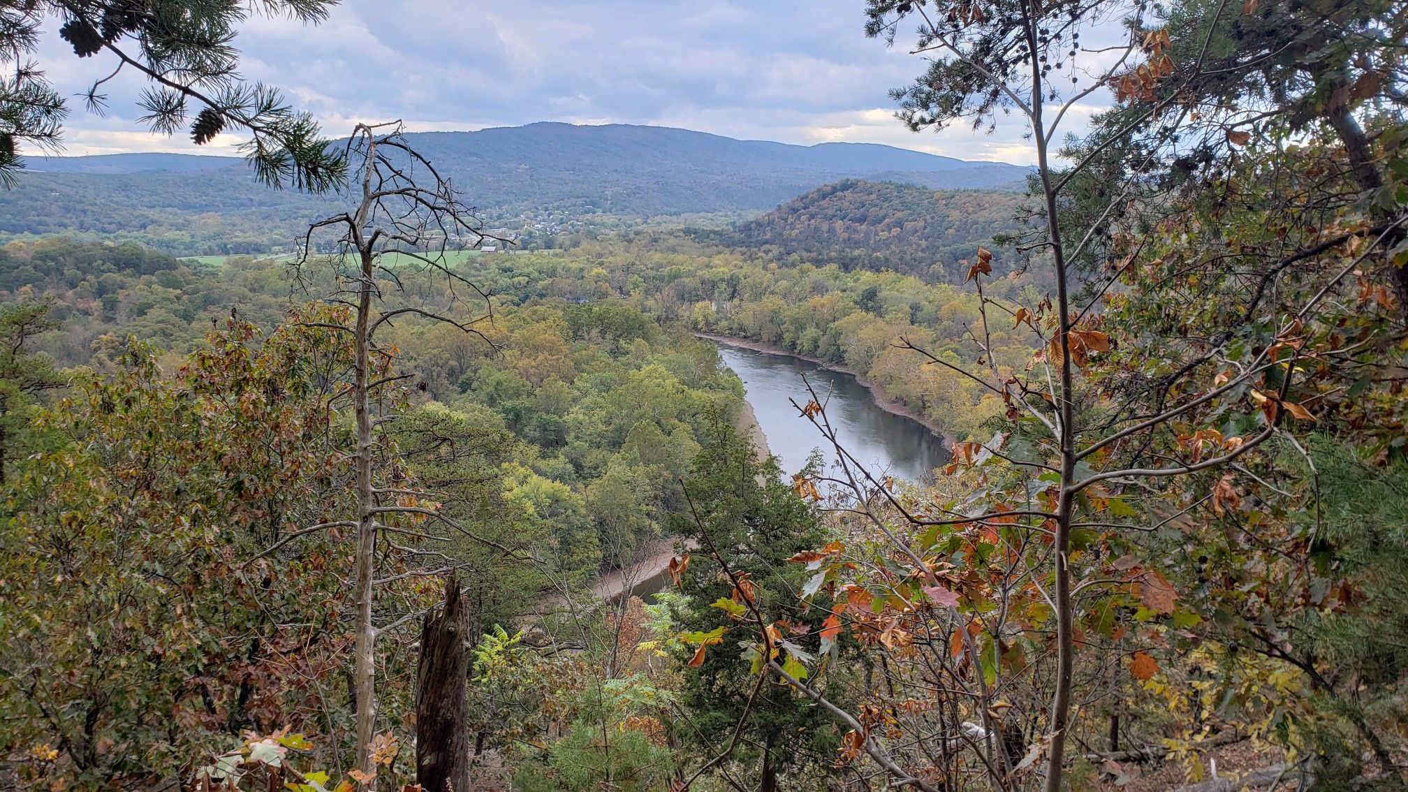 Overcast view of a winding river through a forested valley with distant mountains. - Paw Paw Tunnel – Paw Paw Tunnel loop from Paw Paw Tunnel